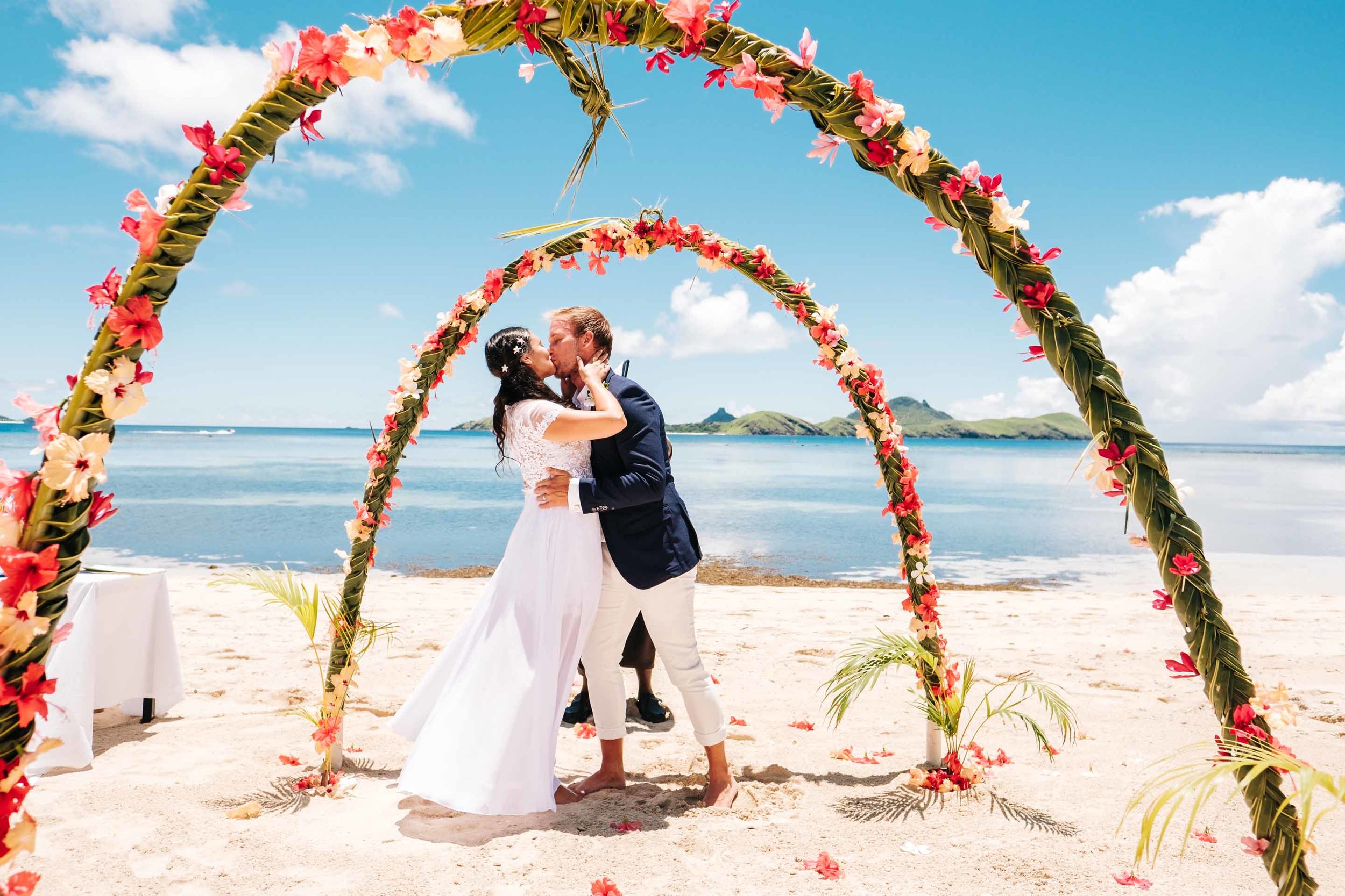 the bride and groom kiss for the first time as husband and wife