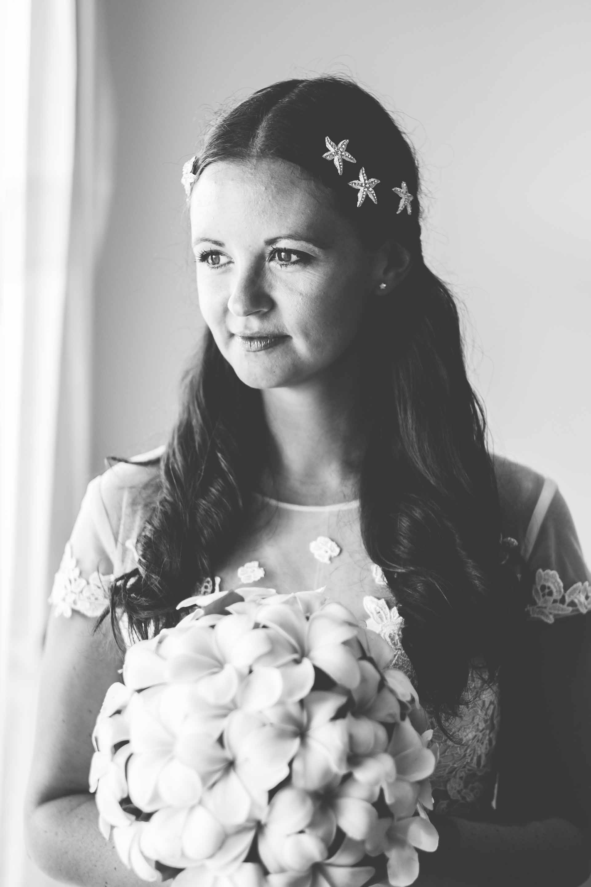 a portrait of the bride with her bouquet in black and white