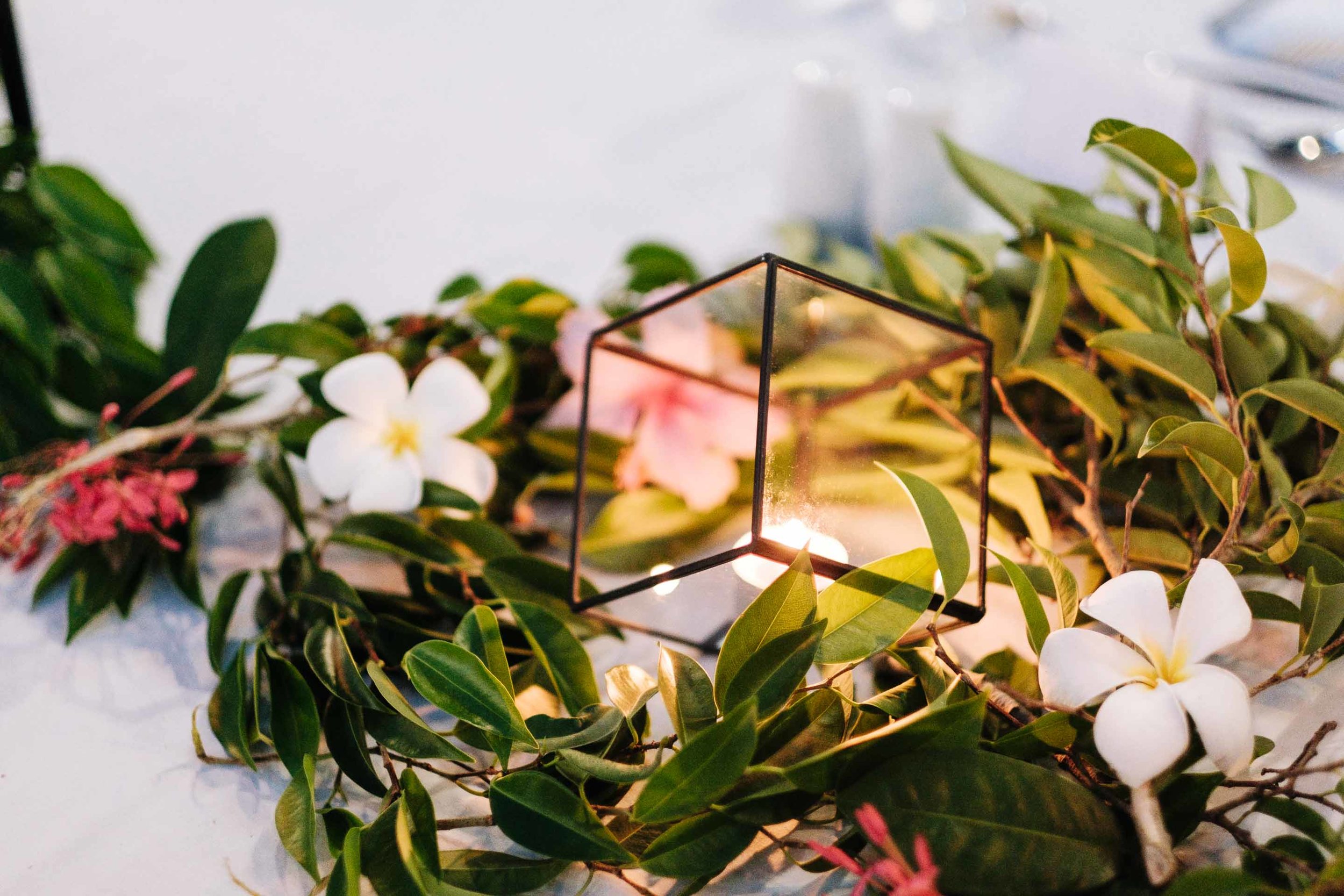geometric candle holder between greenery as part of the bridal table setup