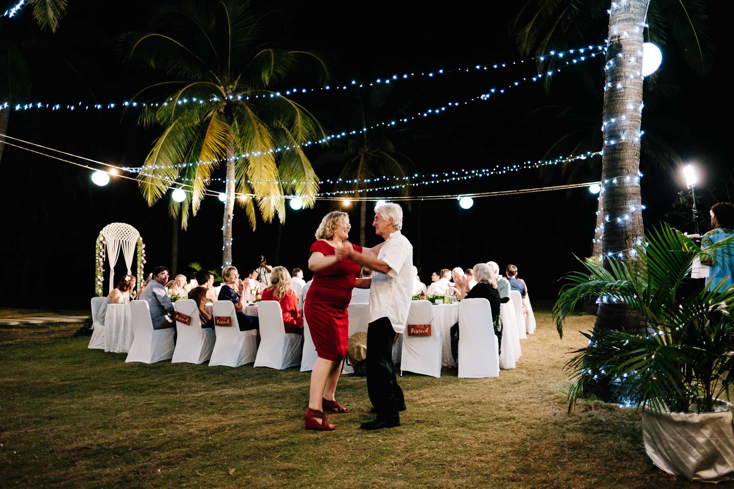 guests dancing at the outdoor reception under the stars and fairy lights