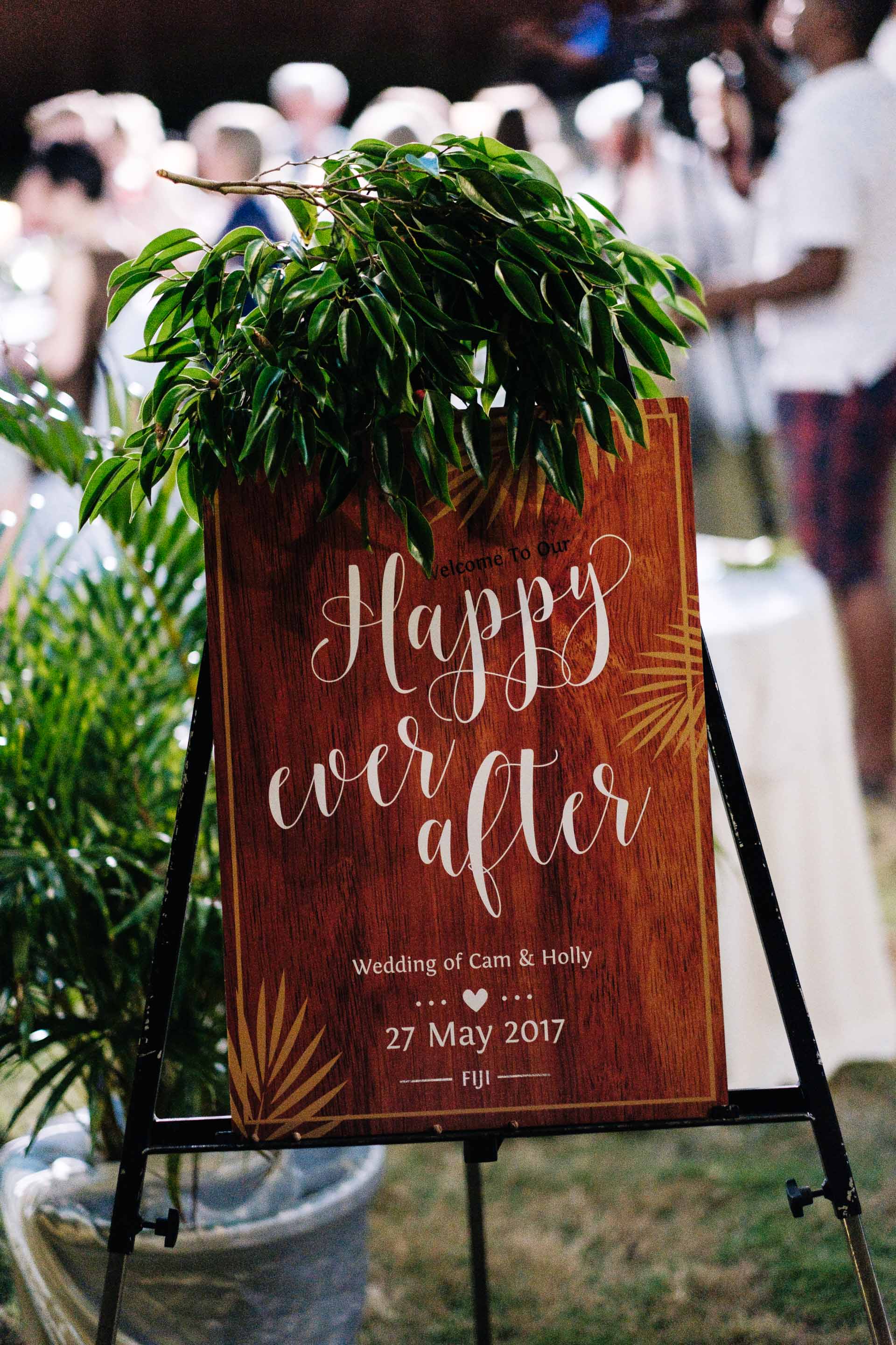 a cutom sign board for the reception venue with the words "happy ever after" printed on it