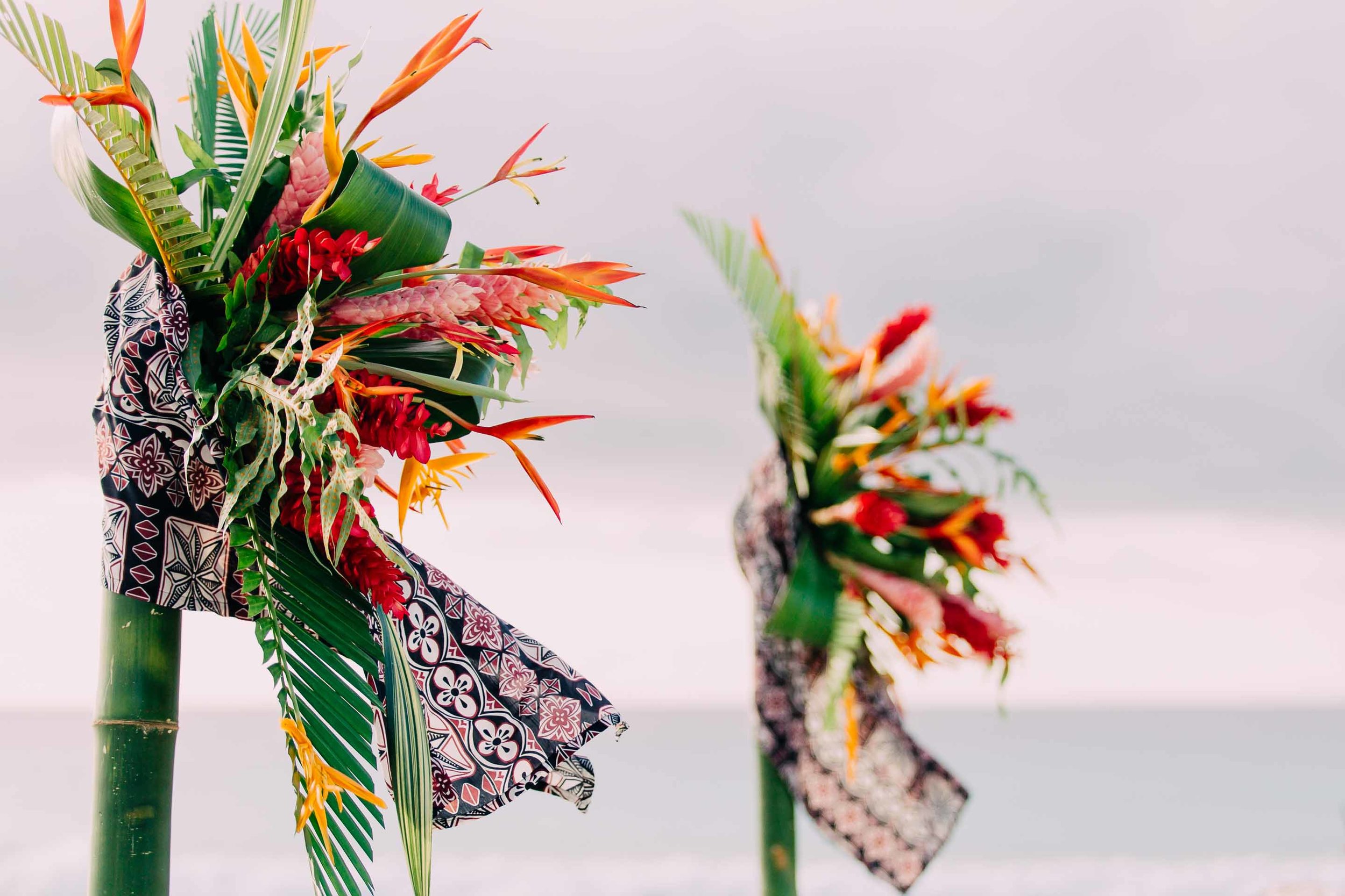 Wedding arch decorations Fijian tapa cloth, tropical Fiji flowers and leaves.