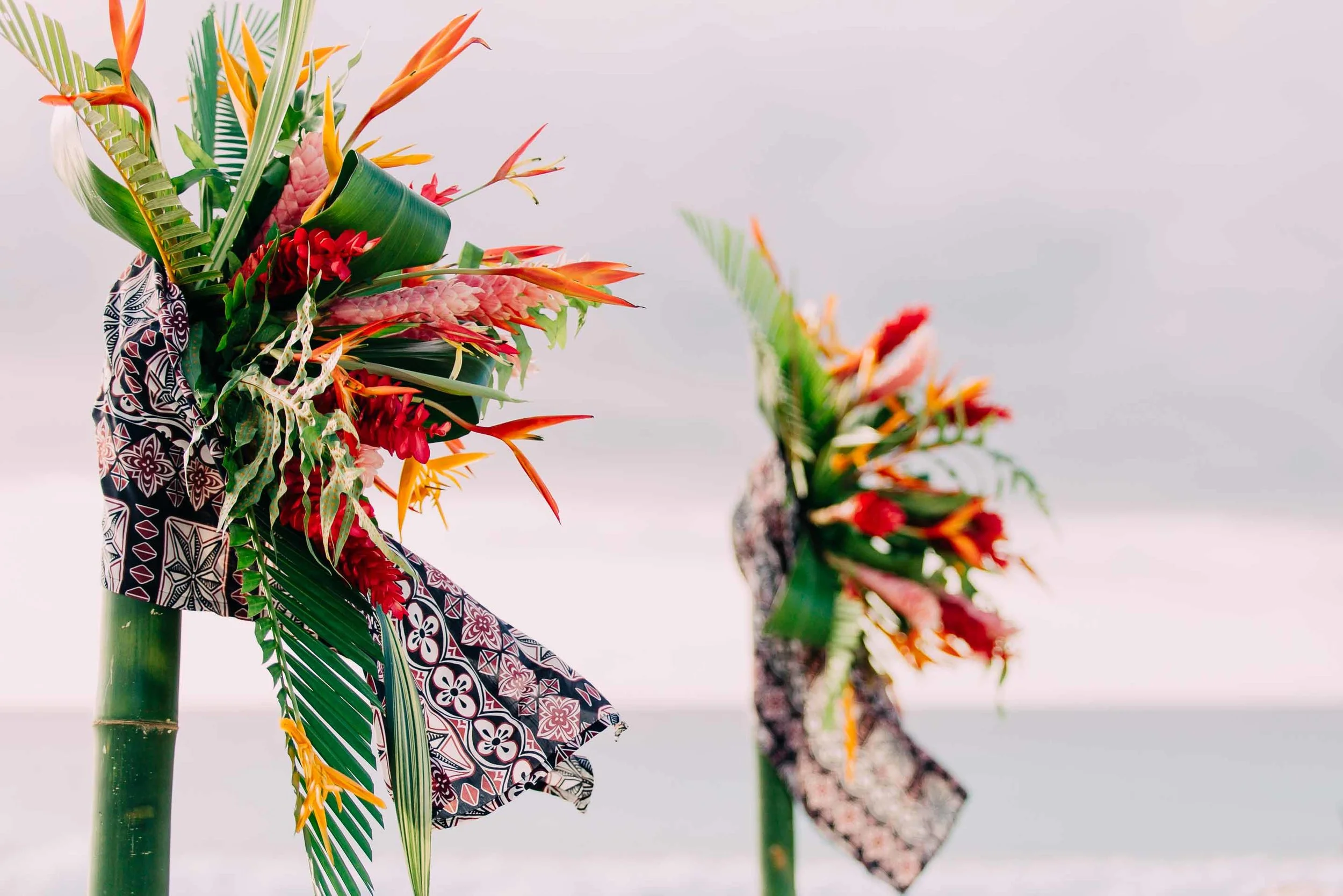 Wedding arch decorations Fijian tapa cloth, tropical Fiji flowers and leaves.