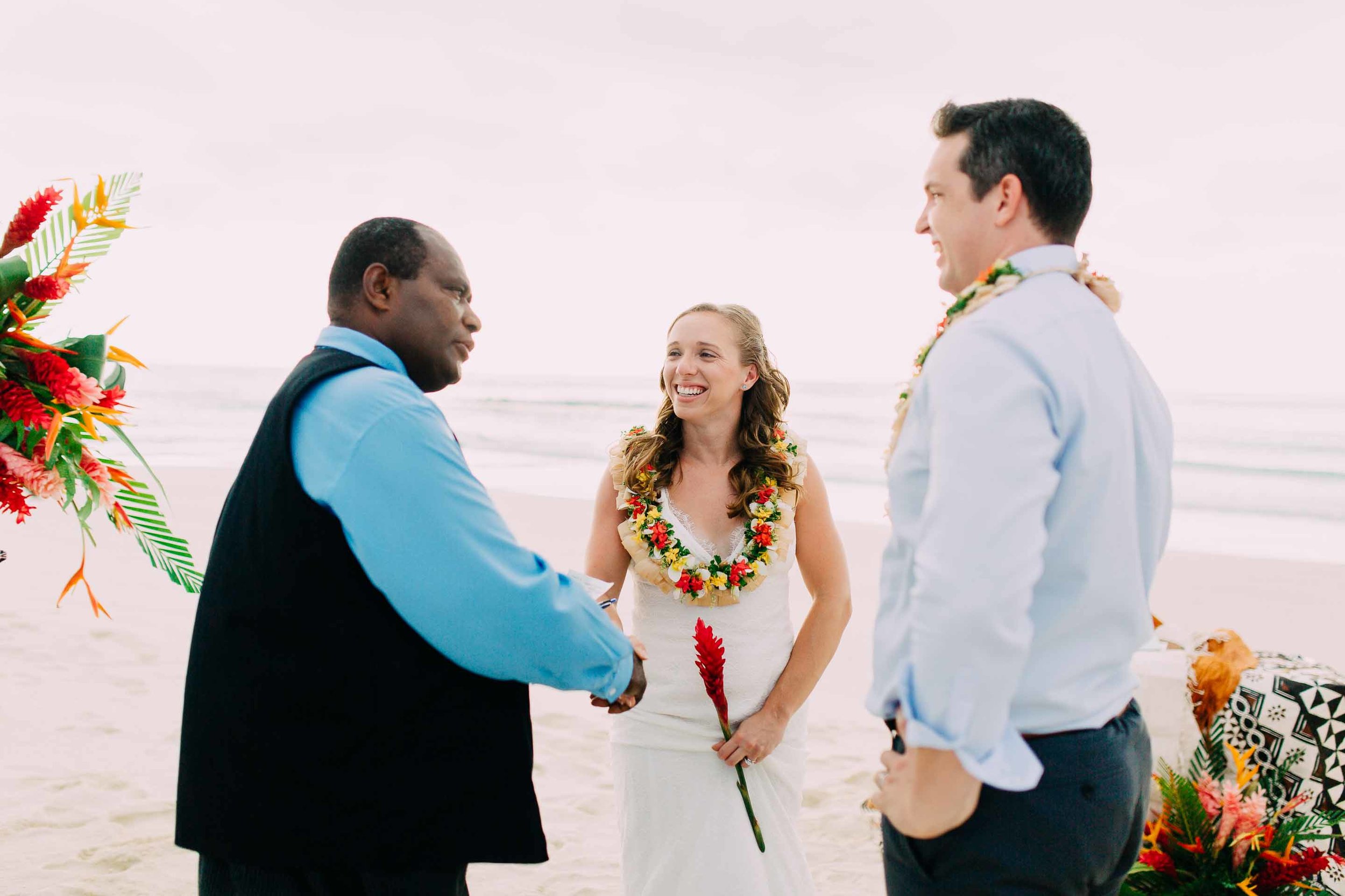 Happy couple shake hands with their marriage celebrant. Happy to be married in Fiji. 