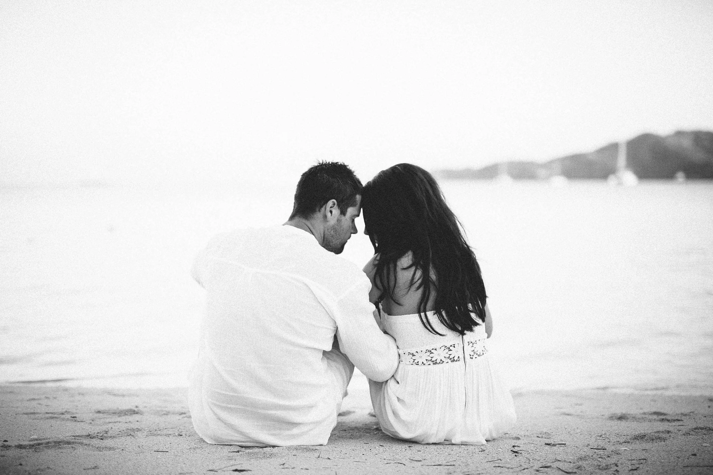 couple sitting together on the beach