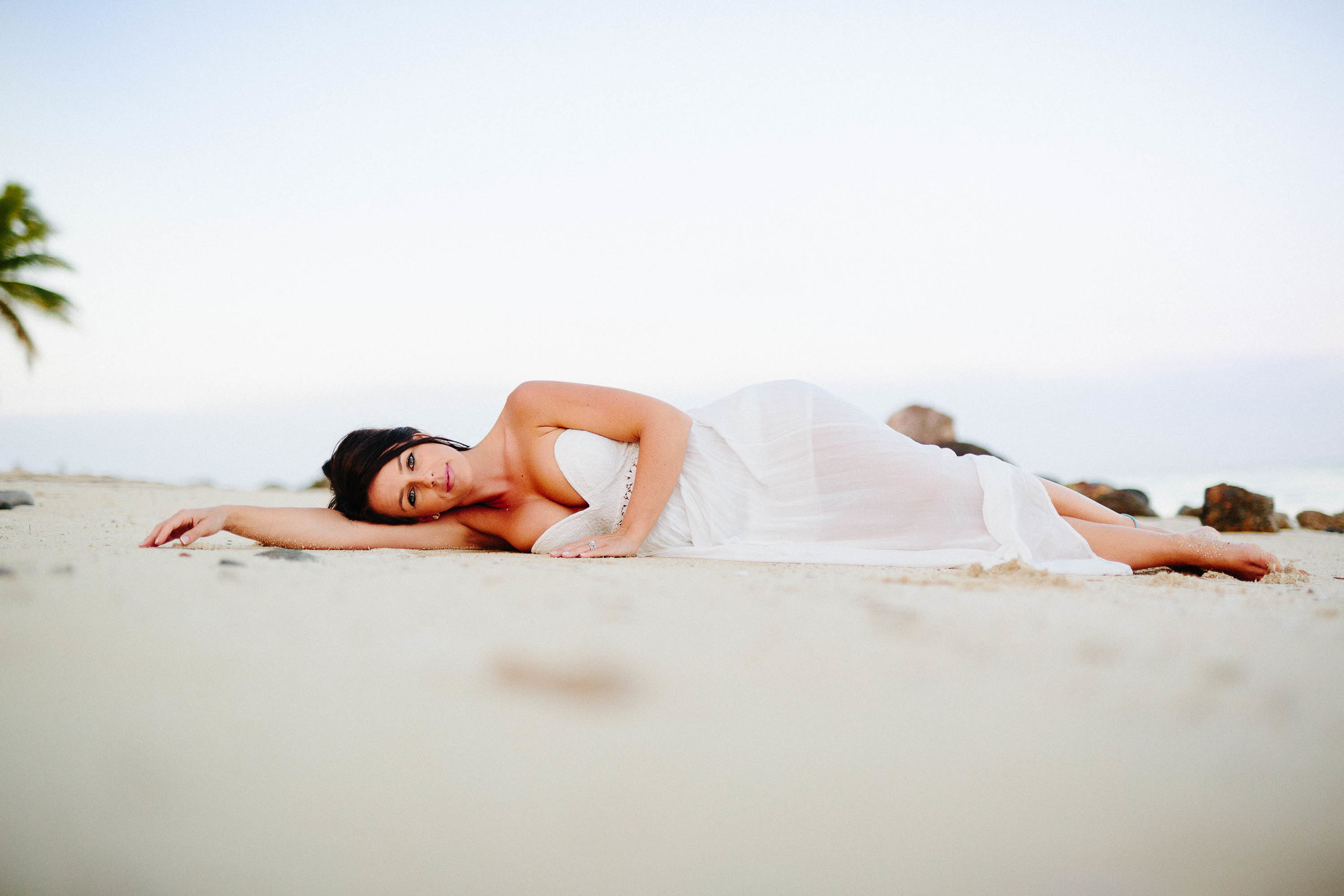 bride laying on beach