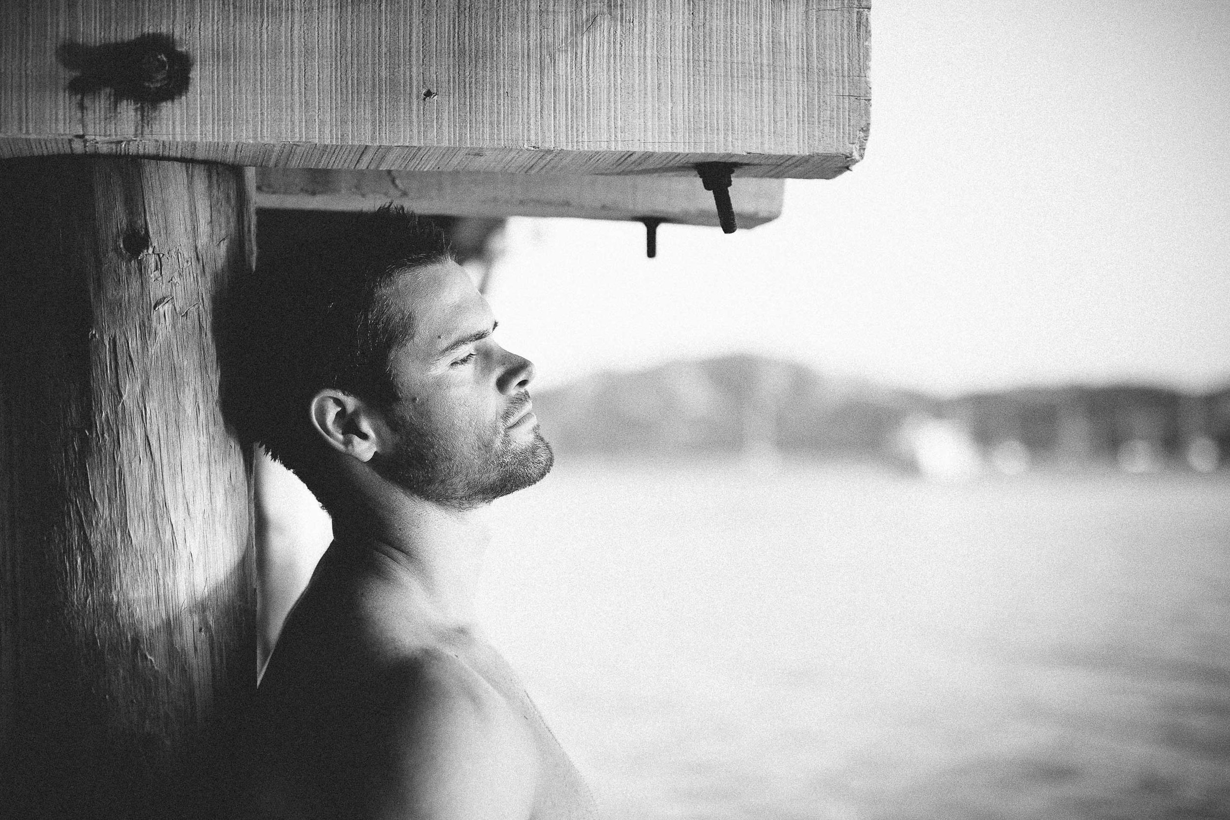 Groom posing under the pier