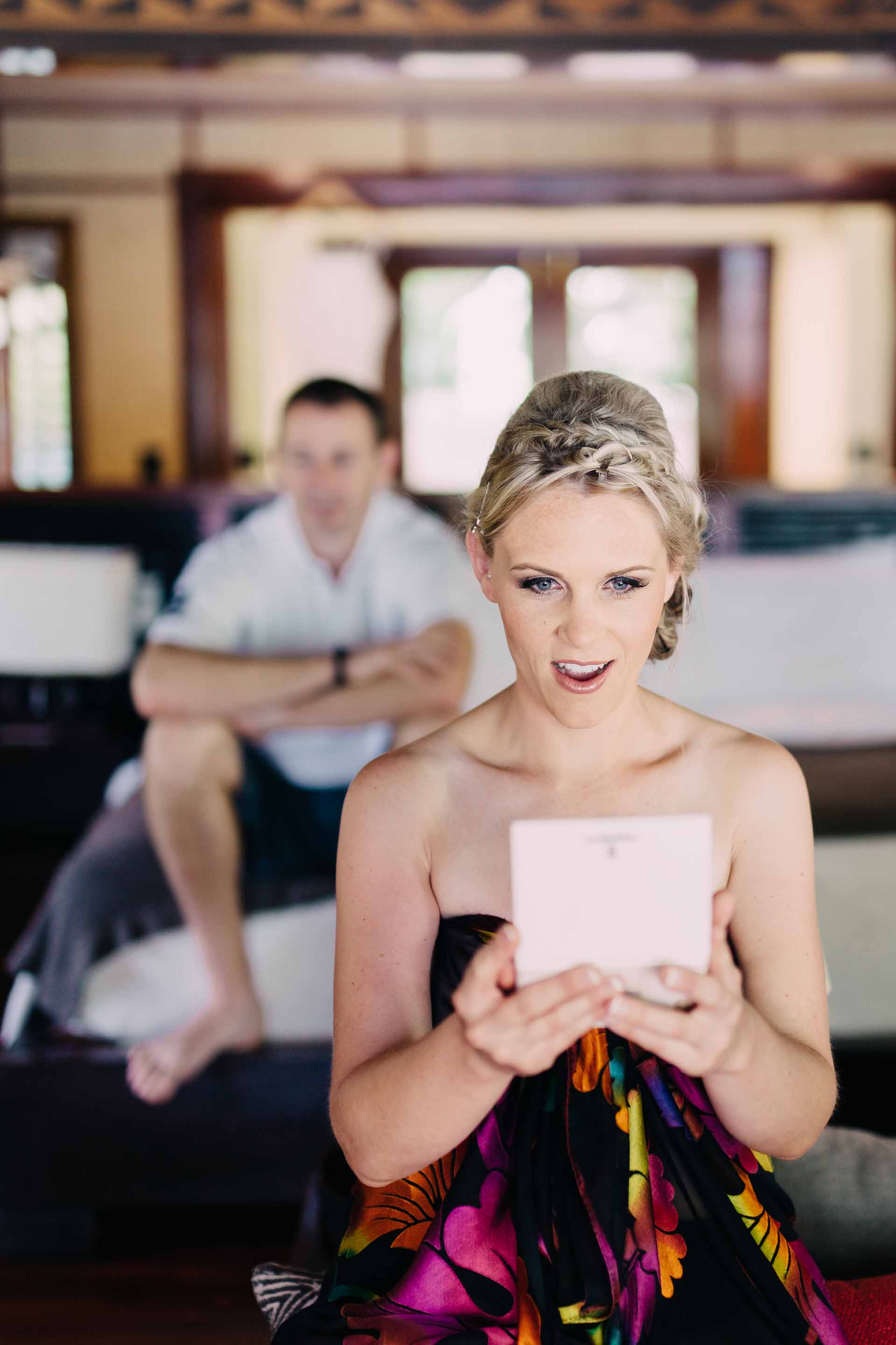 the bride looking in the mirror after hair and makeup have finishe