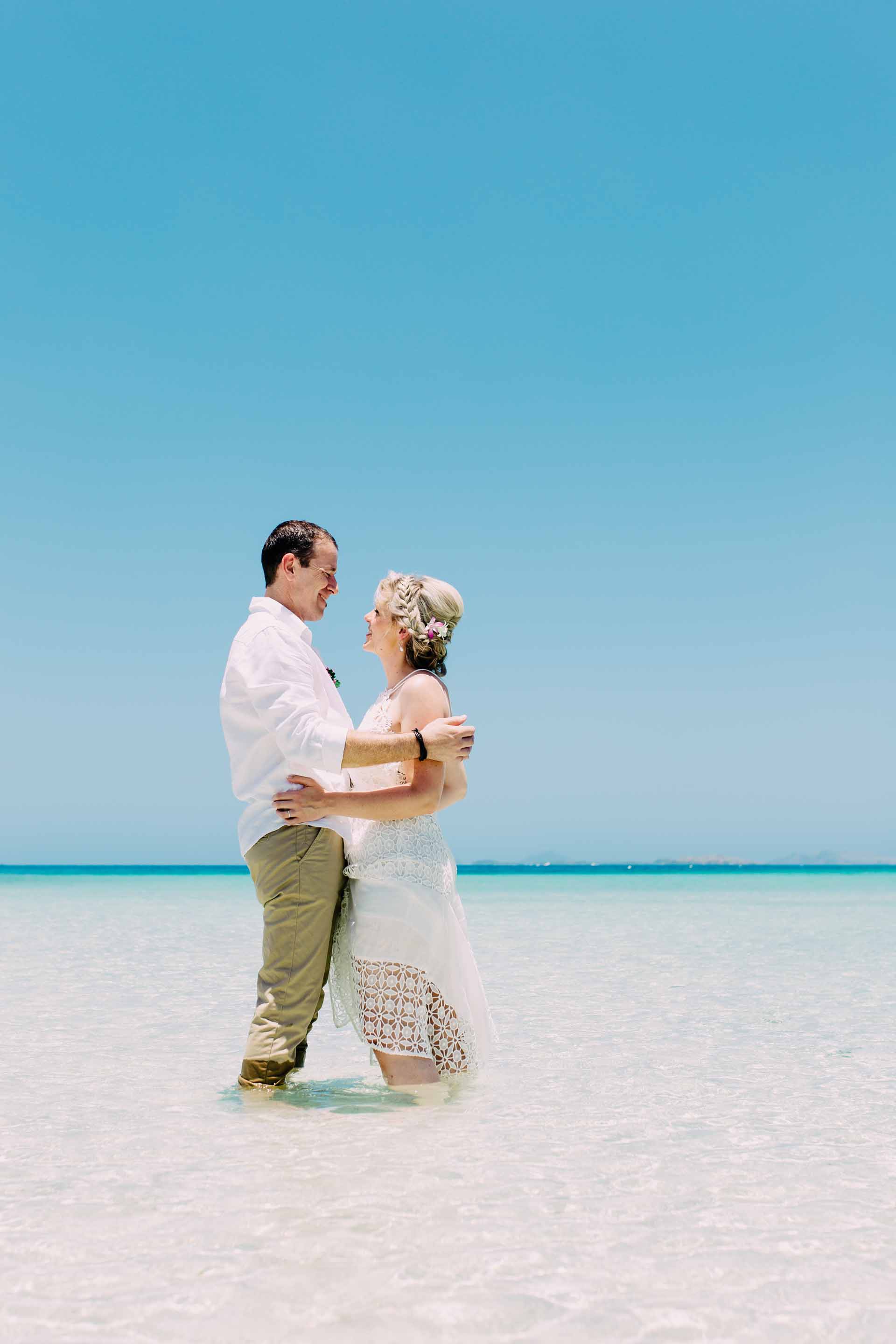 knee deep in the crystal clear fiji waters at likuliku island resort