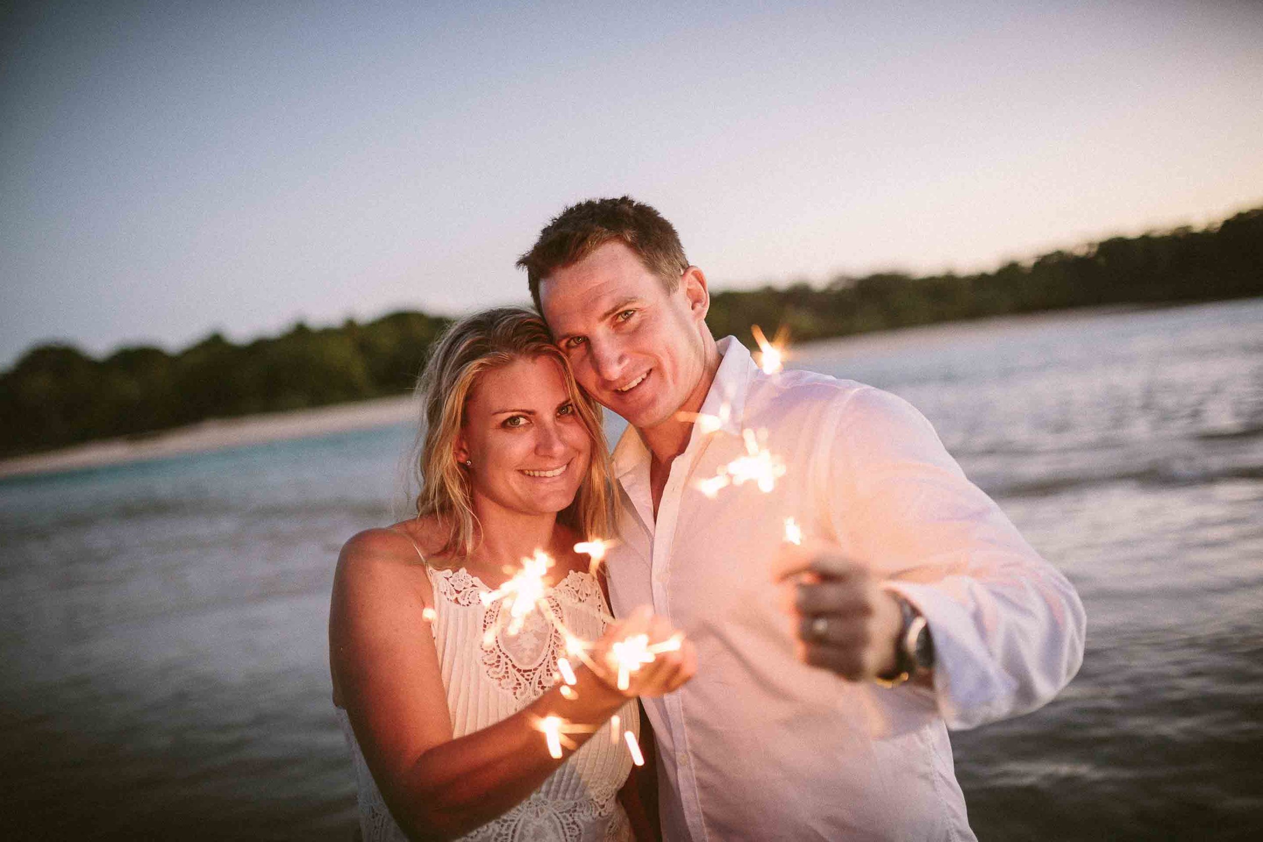 the couple holding sparklers