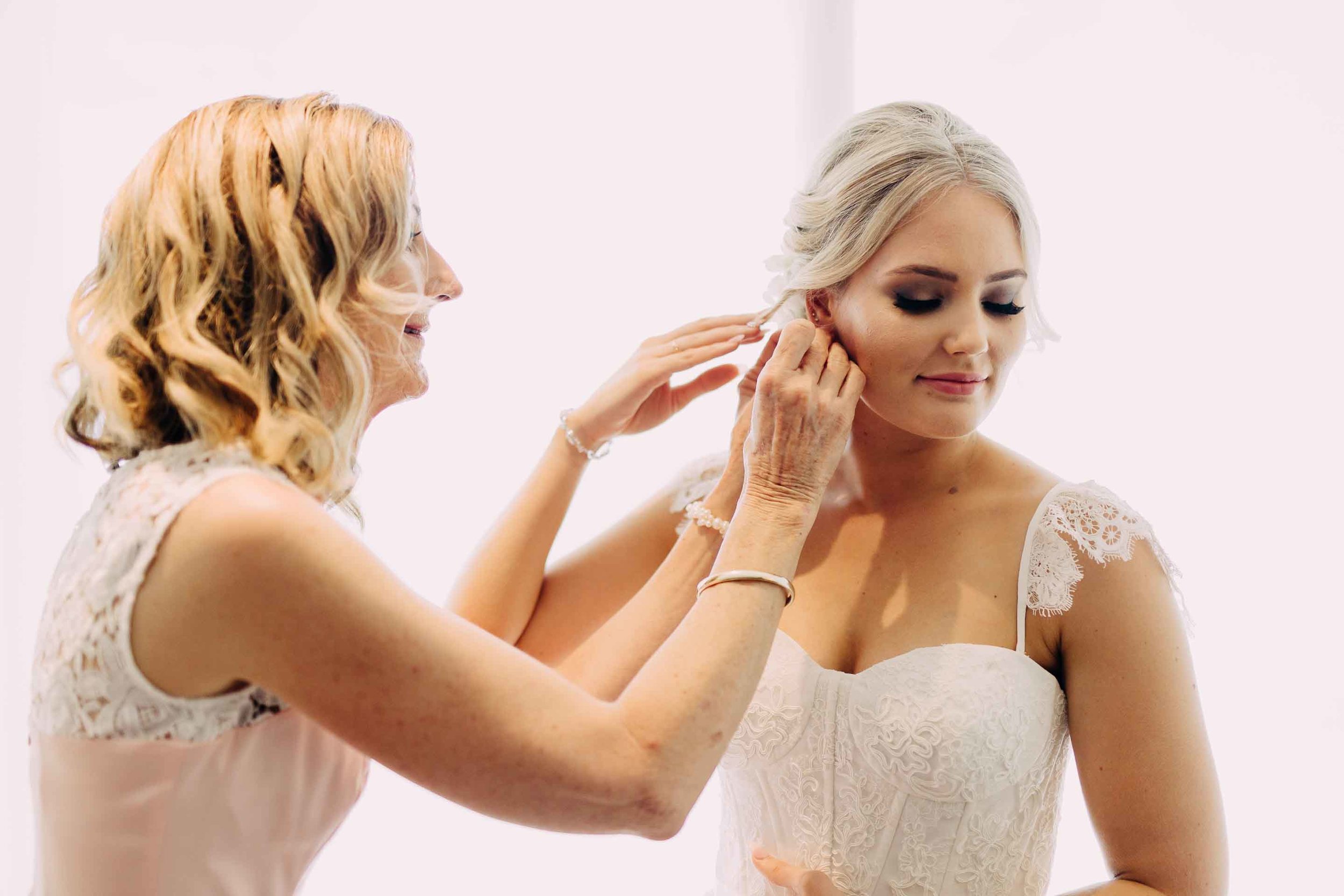 Bride puts on her earrings