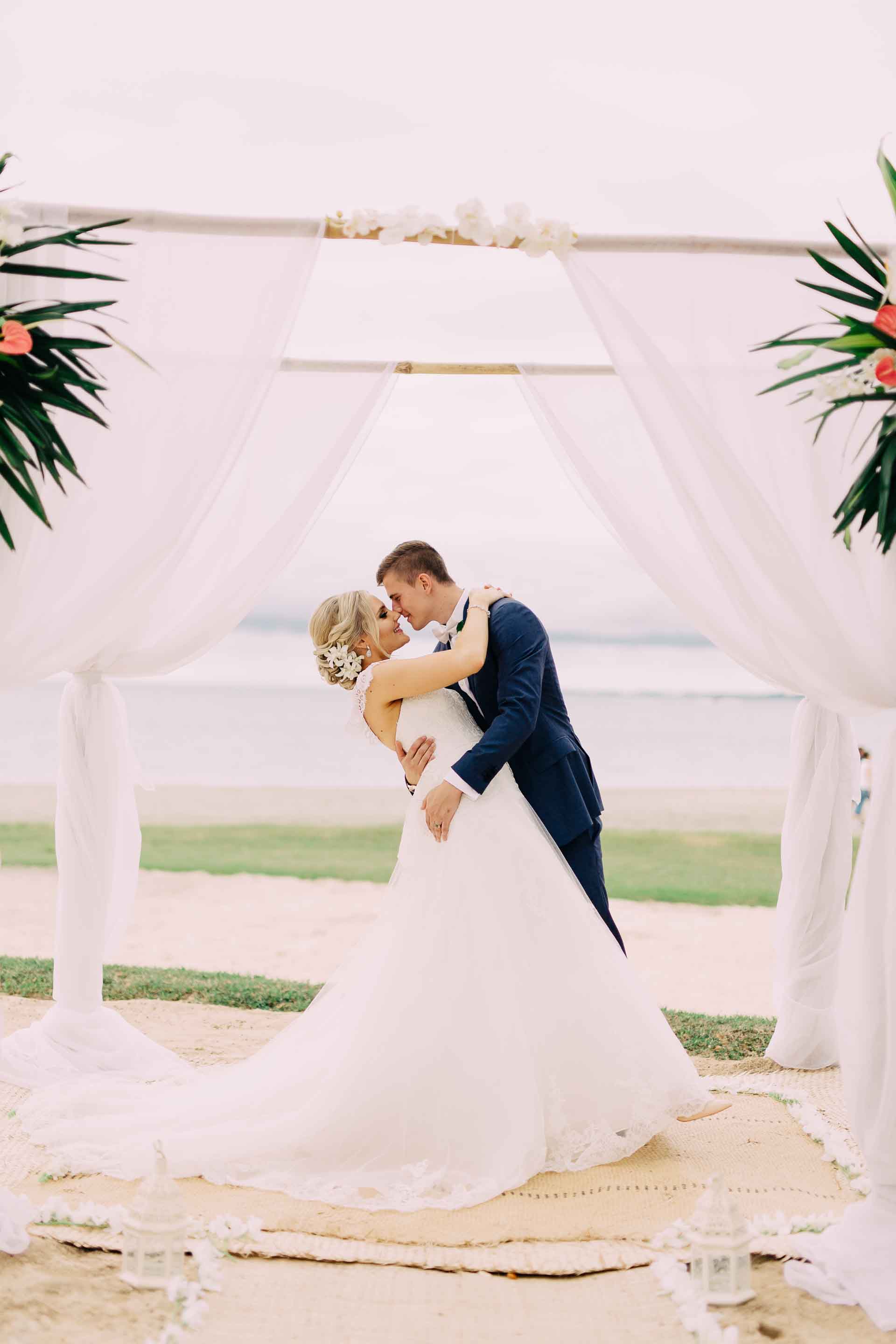 Bride &amp; Groom embrace and kiss after the wedding. 