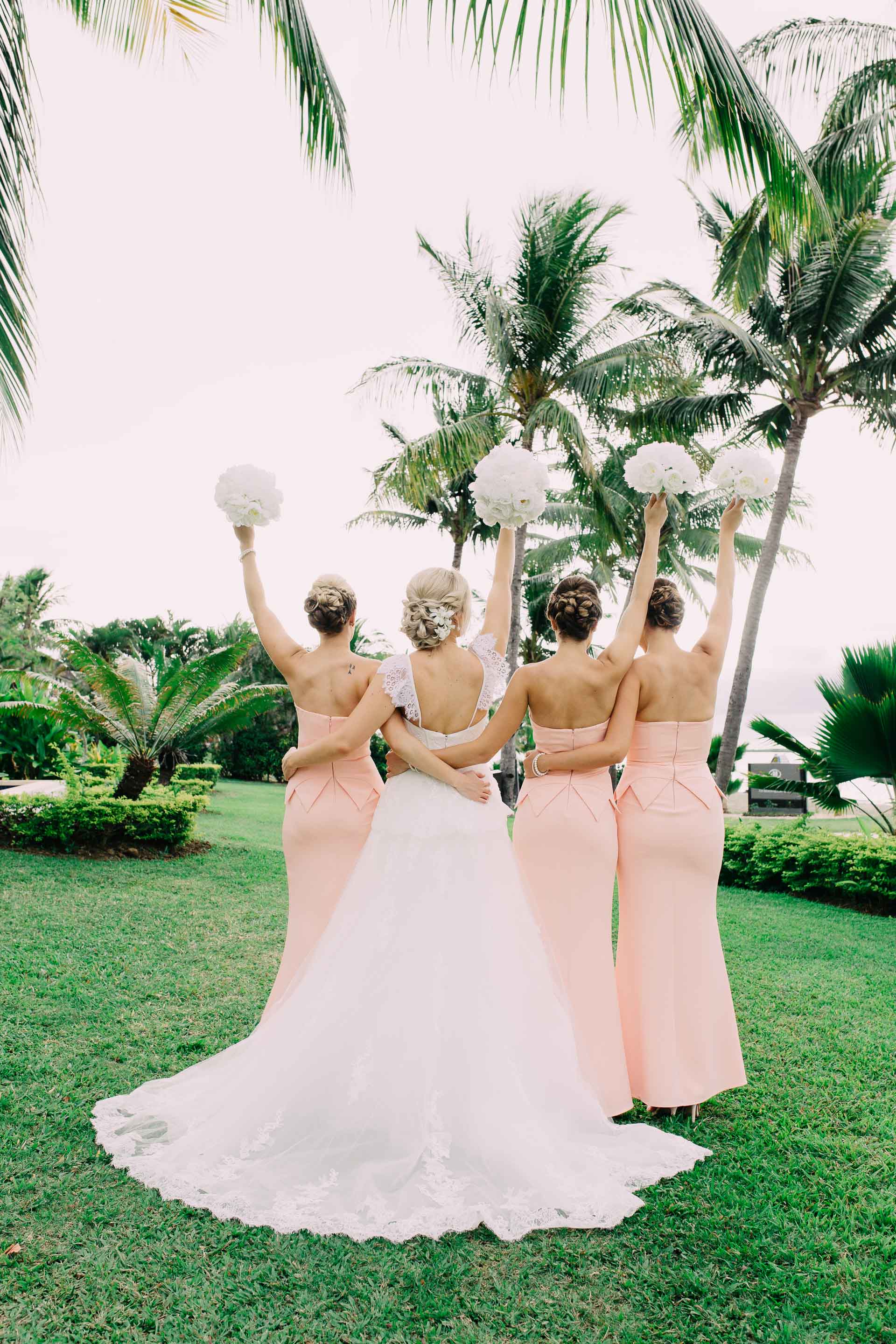 Bride with her Bridesmaids back shot with their white peony bouquets.