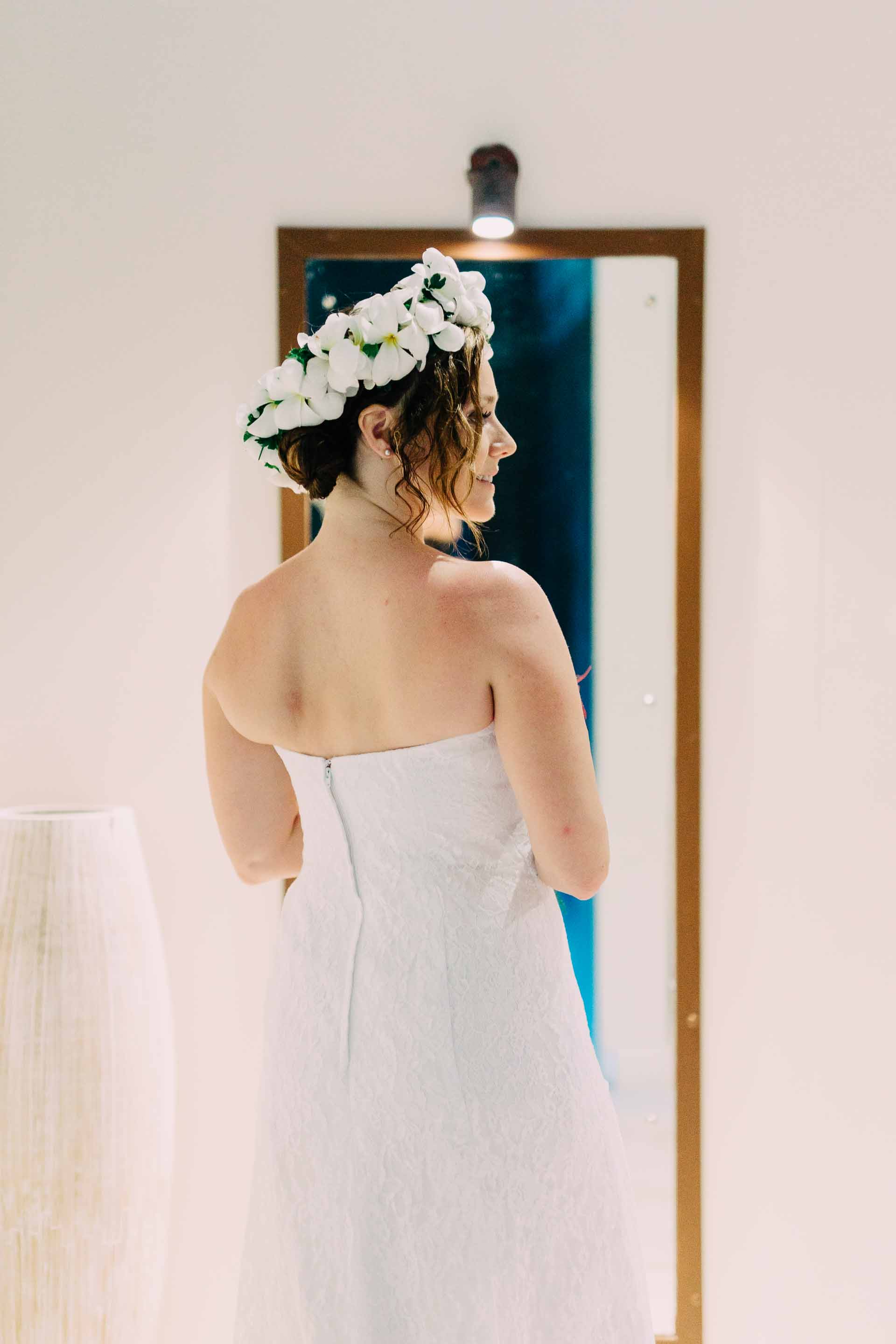 the bride looking at herself in a mirror