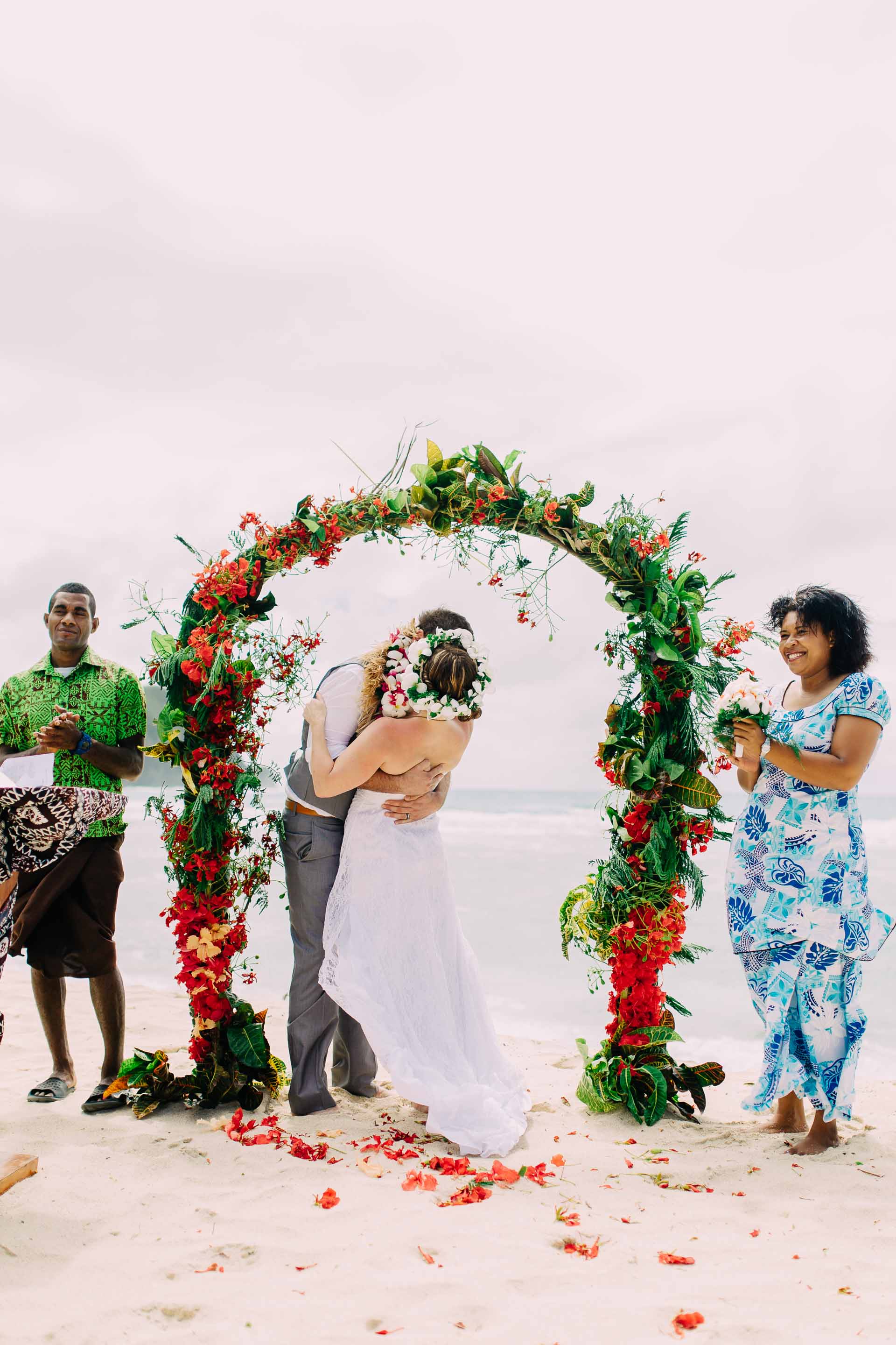 the bride and groom kissing for the first time as manand wife