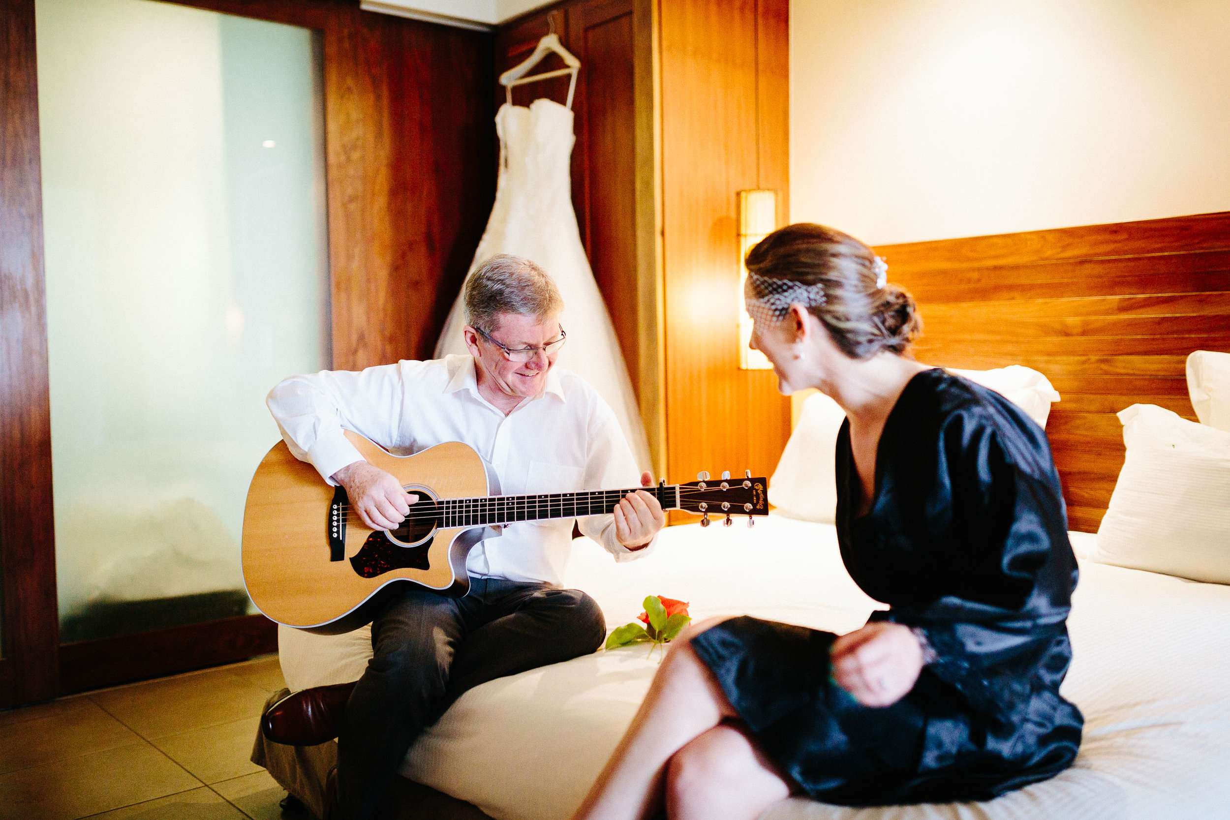 the brides father playing a song for his daughter