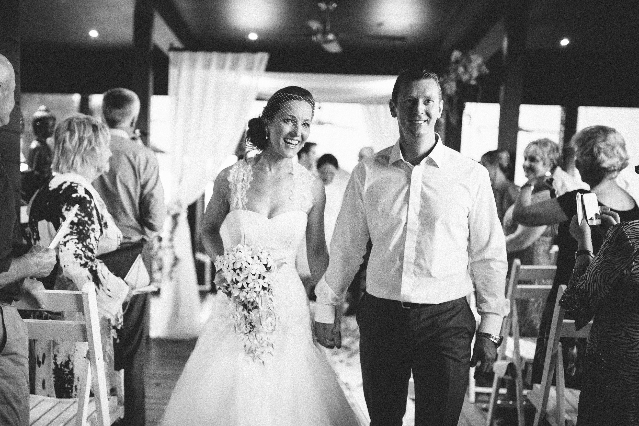 Bride and groom walking down the aisle as husband and wife