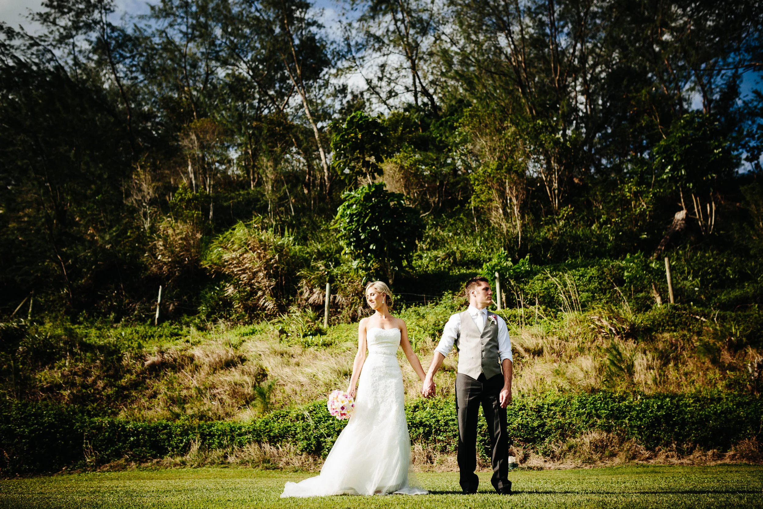 The newlyweds standing in a field