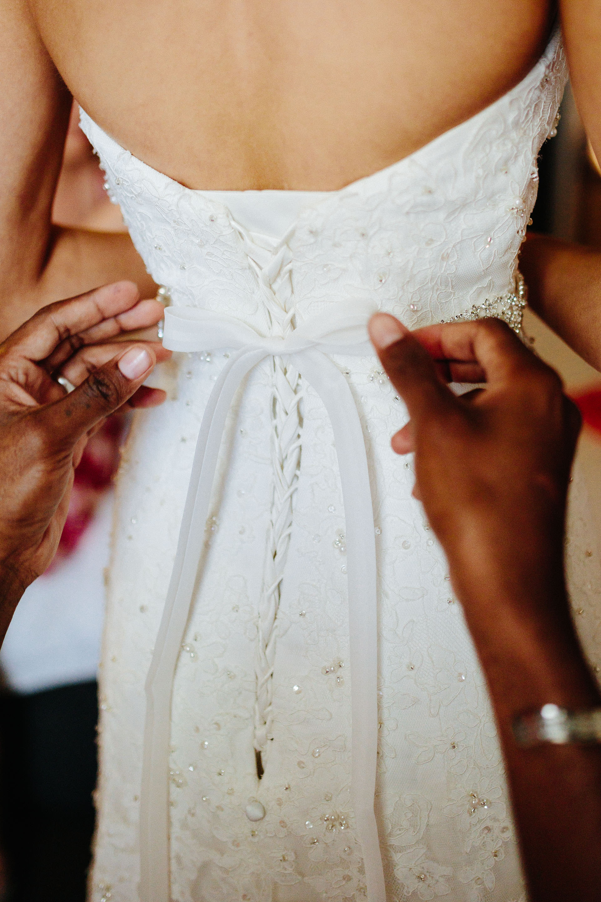 putting on the wedding dress