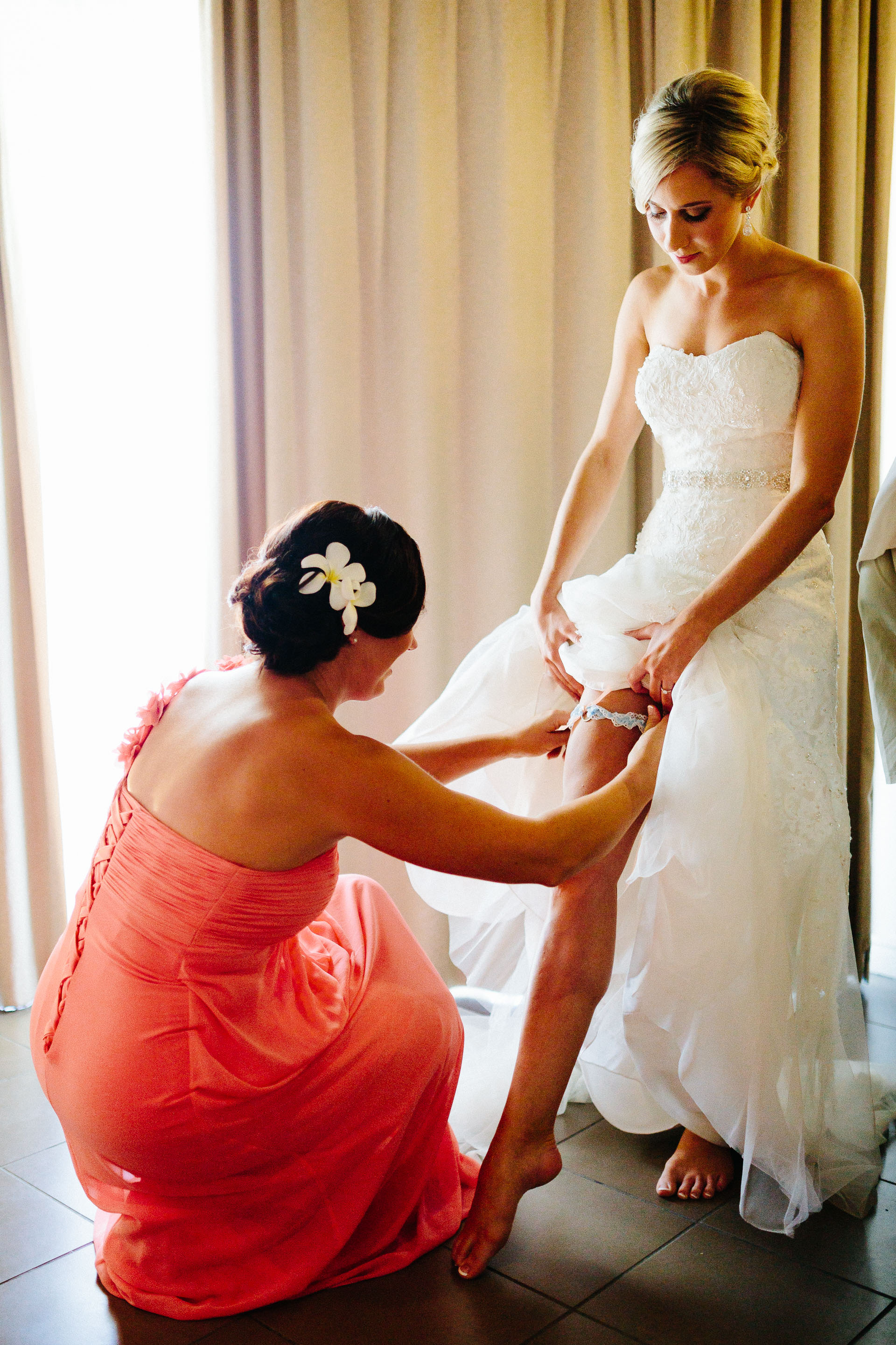 bride putting on garter belt