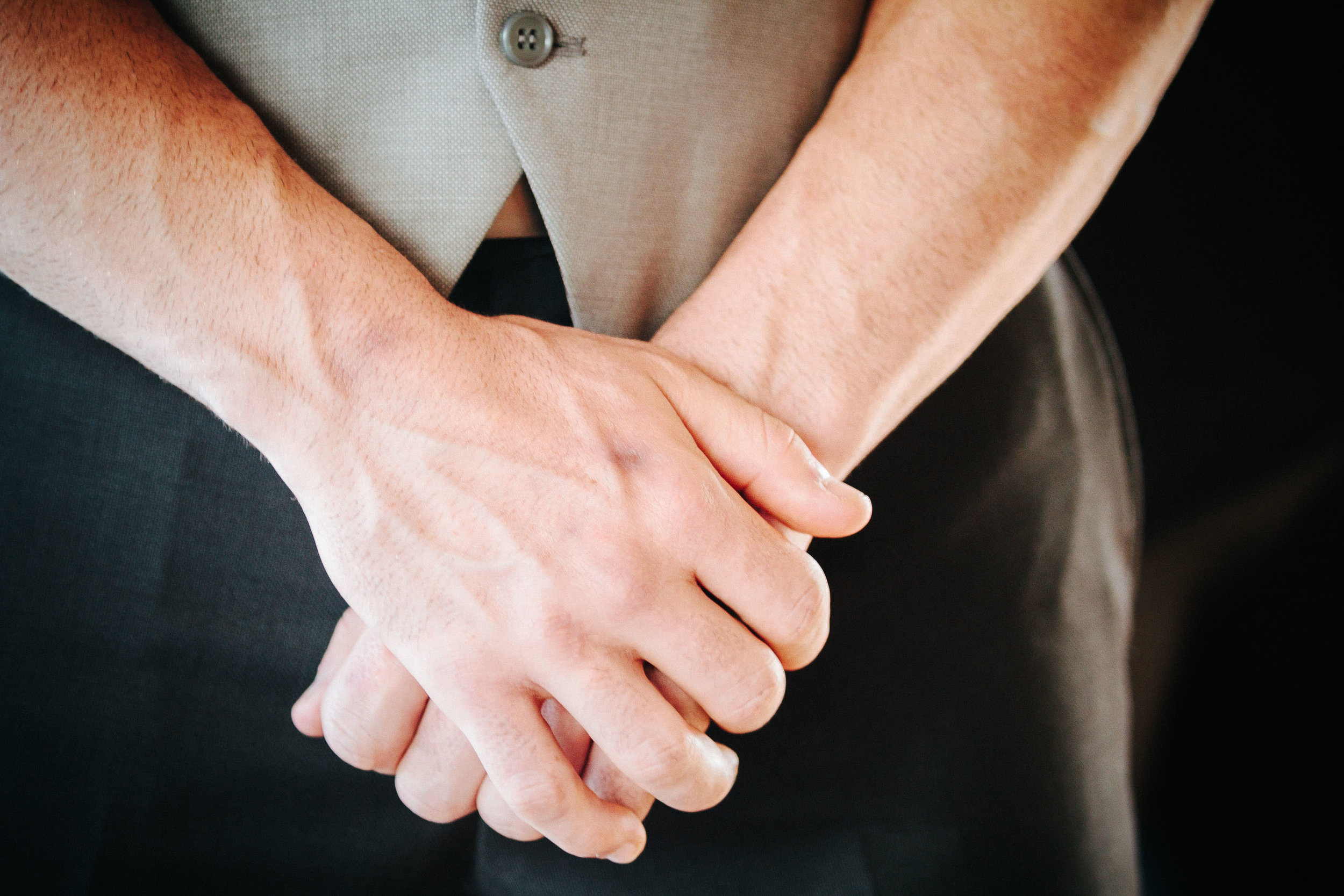 groom crossed hands waiting nervously