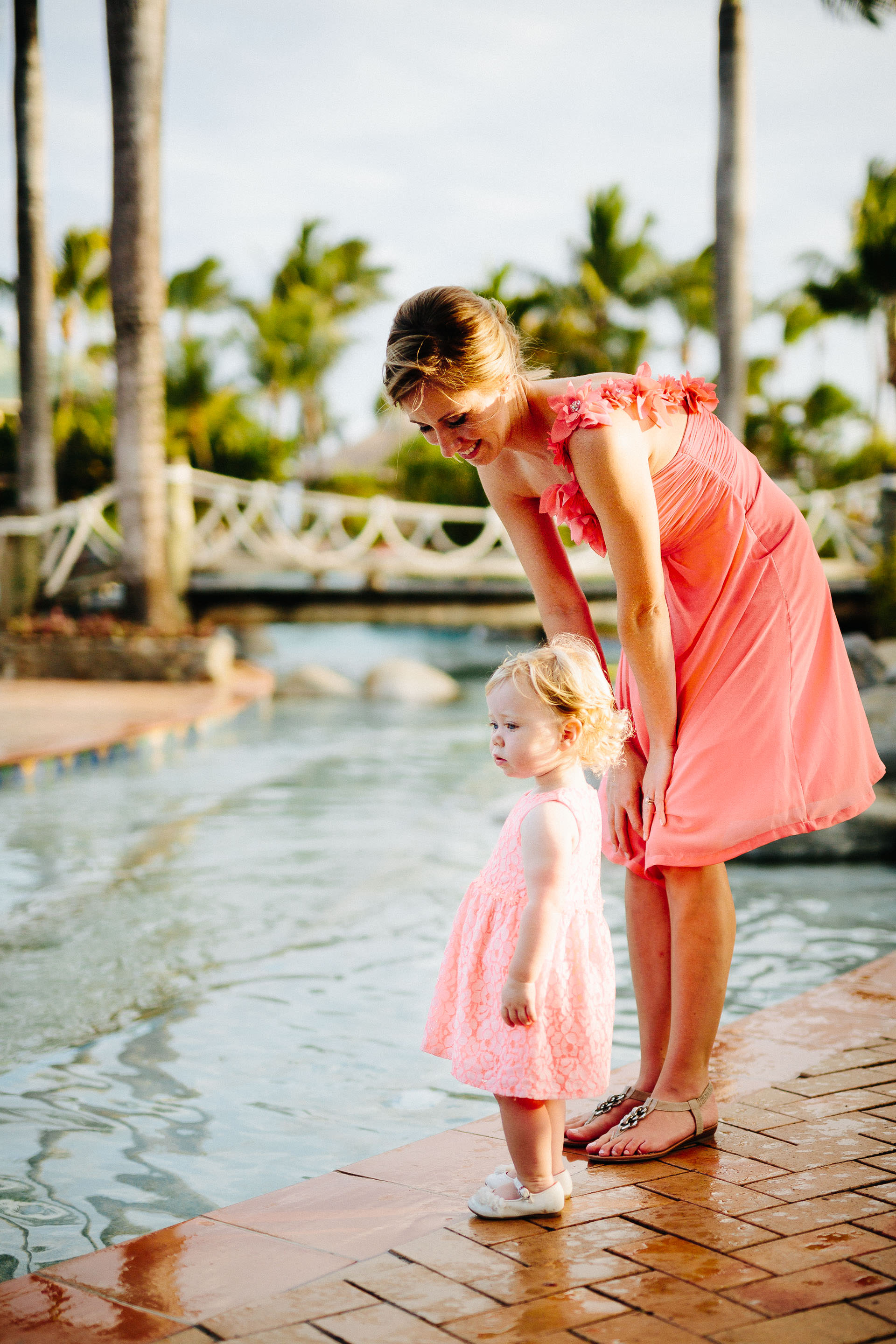 bridesmaid watching her daughter next to the pool