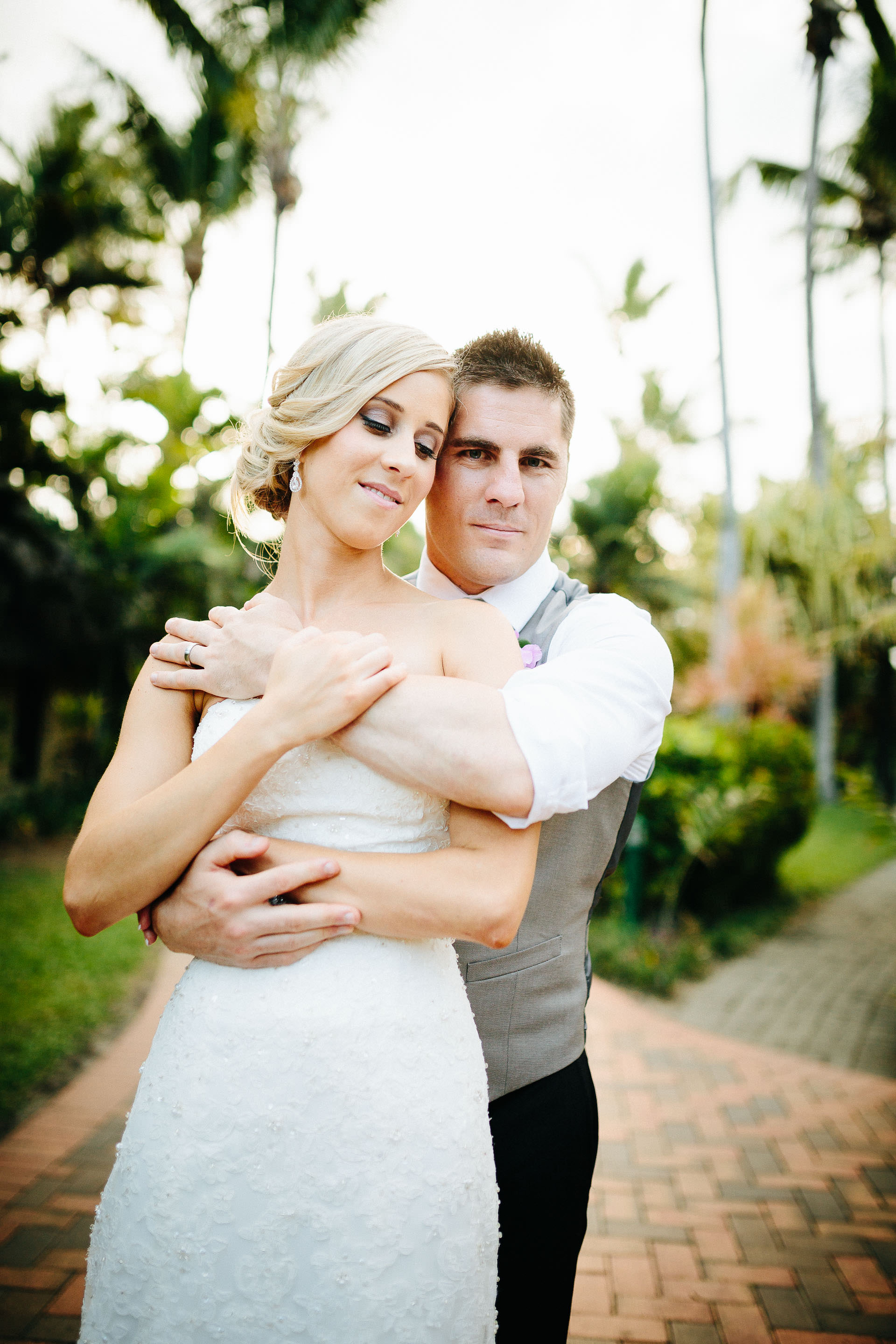 groom hugging bride from behind