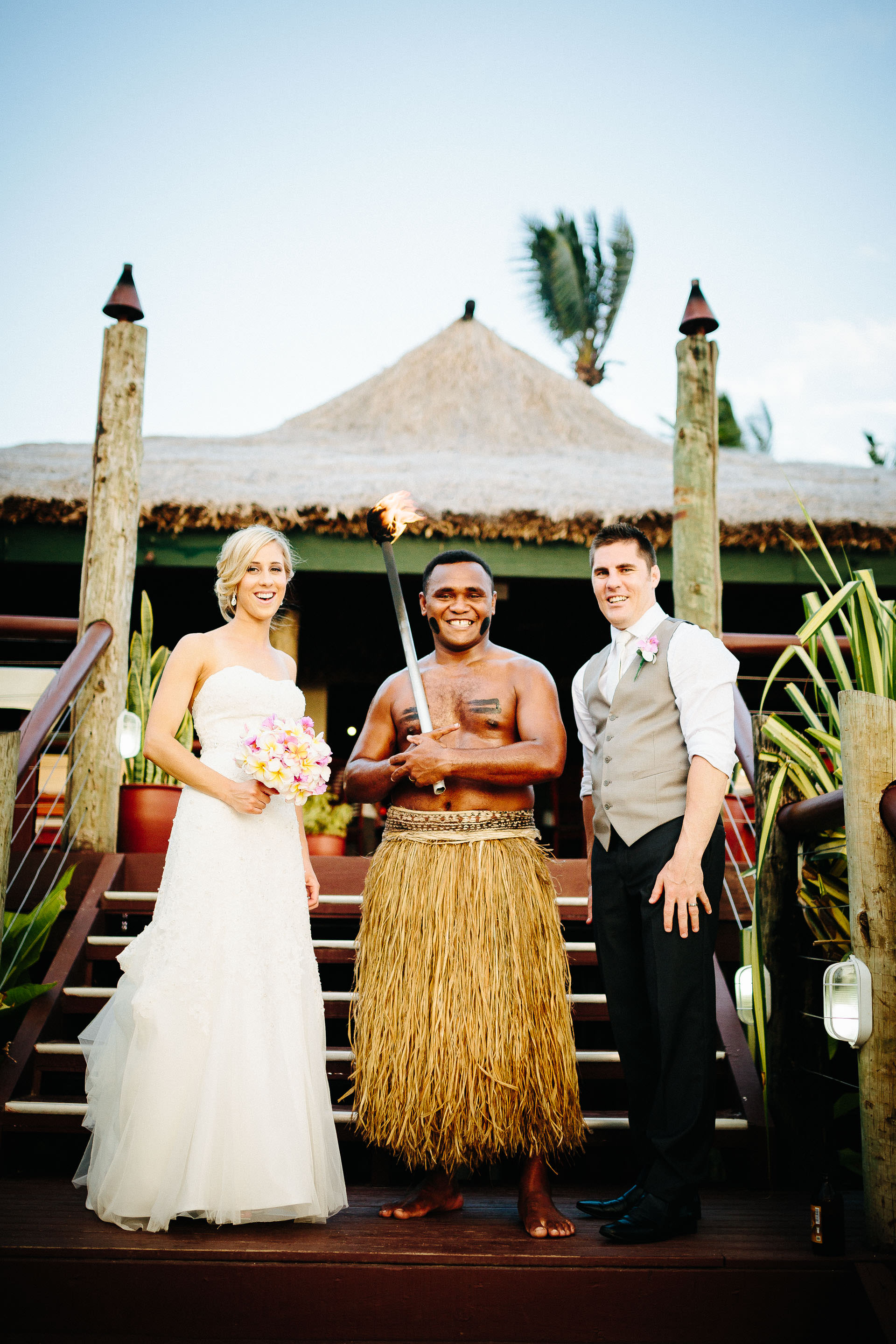bride and groom with Fijian warrior