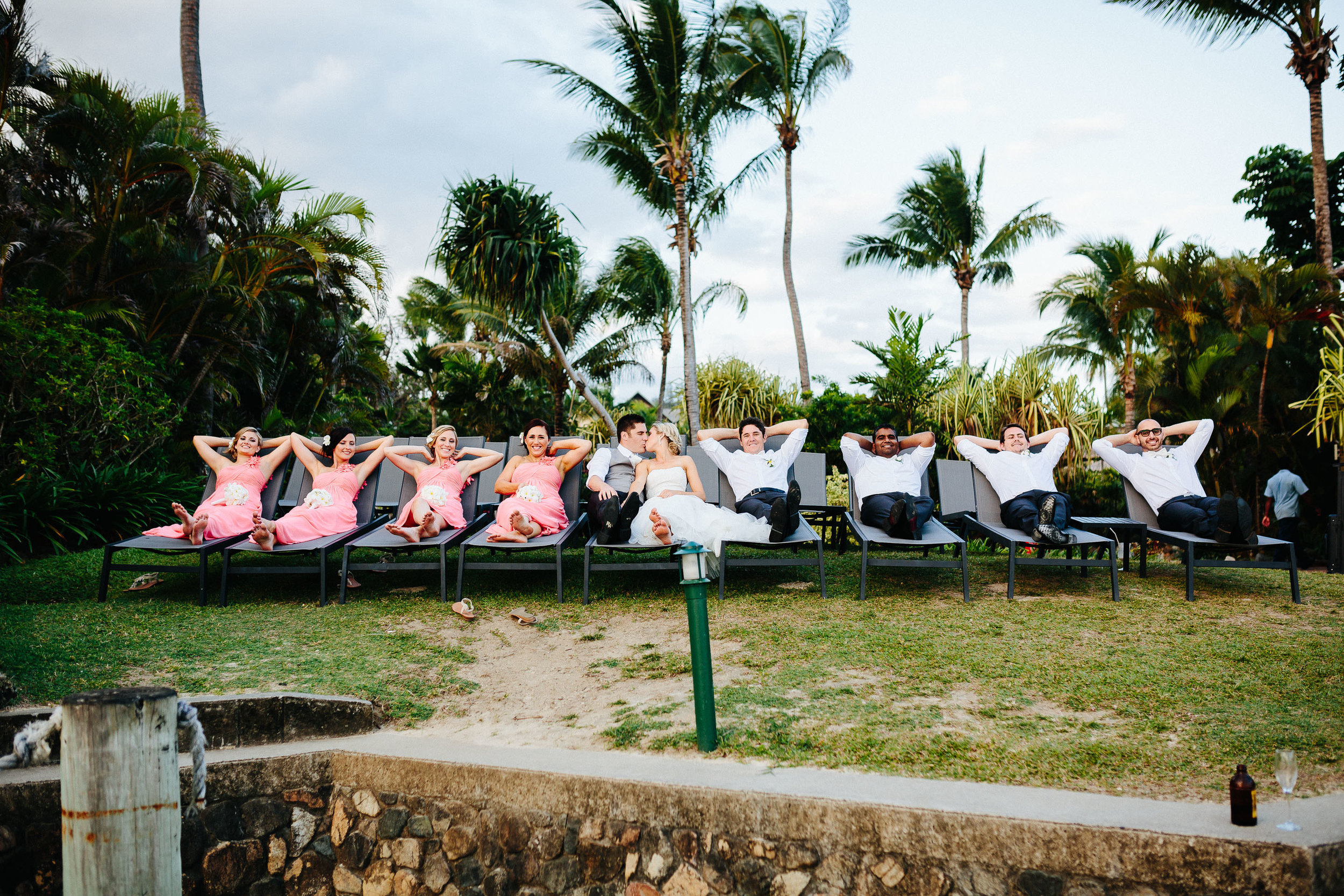 bridal party resting on sun beds