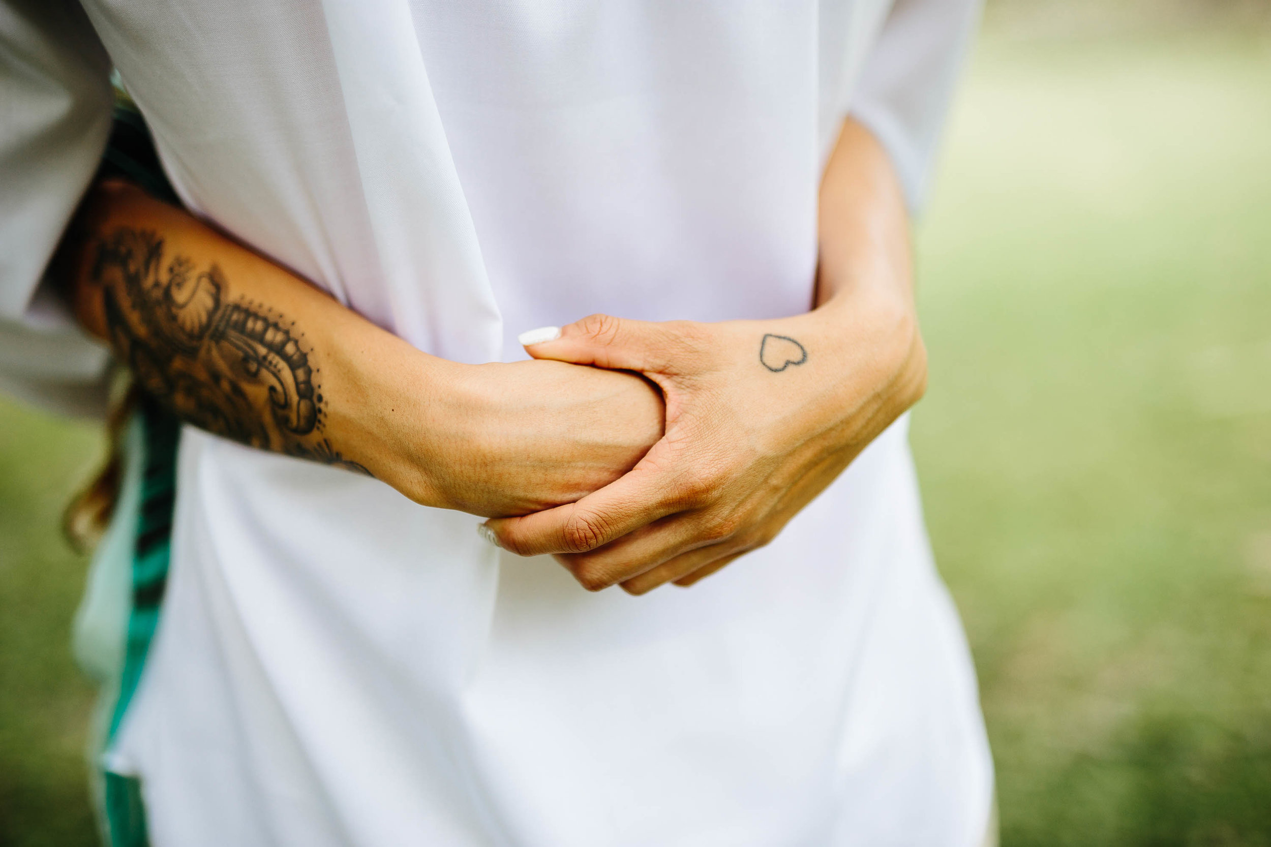 brides hands on grooms back