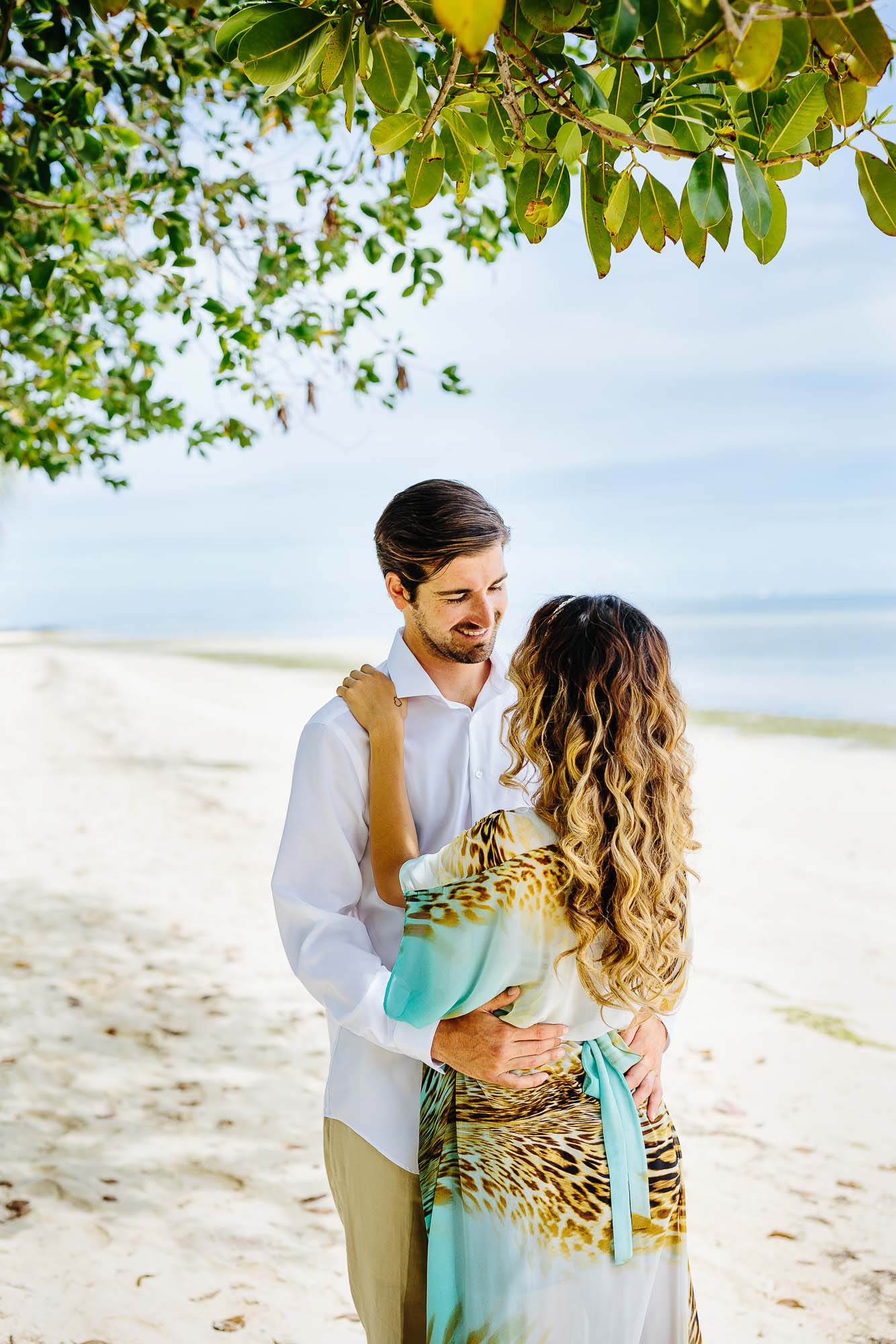 bride and groom on the beach in the shade