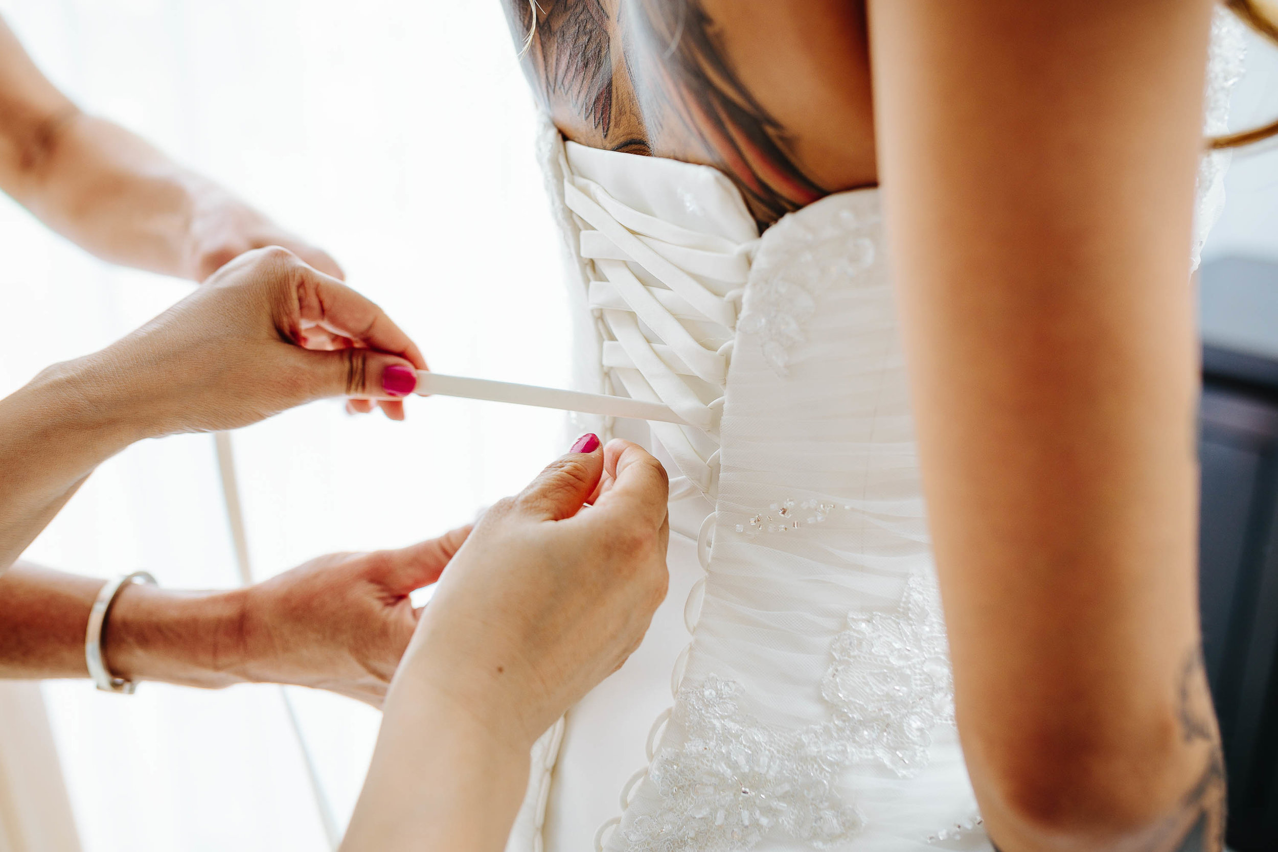 bridal gown being laced up
