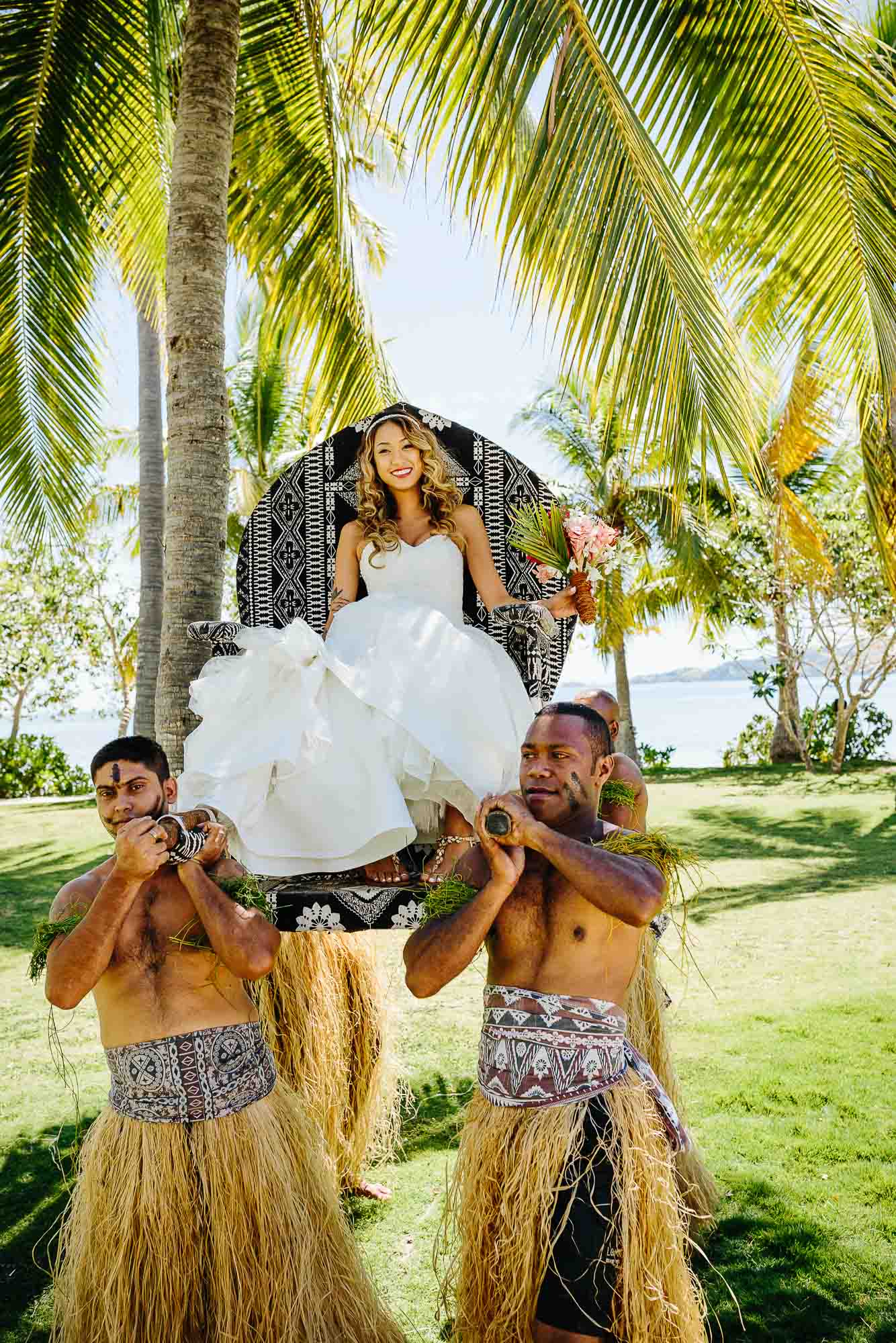 Fijian warriors carrying bride to ceremony