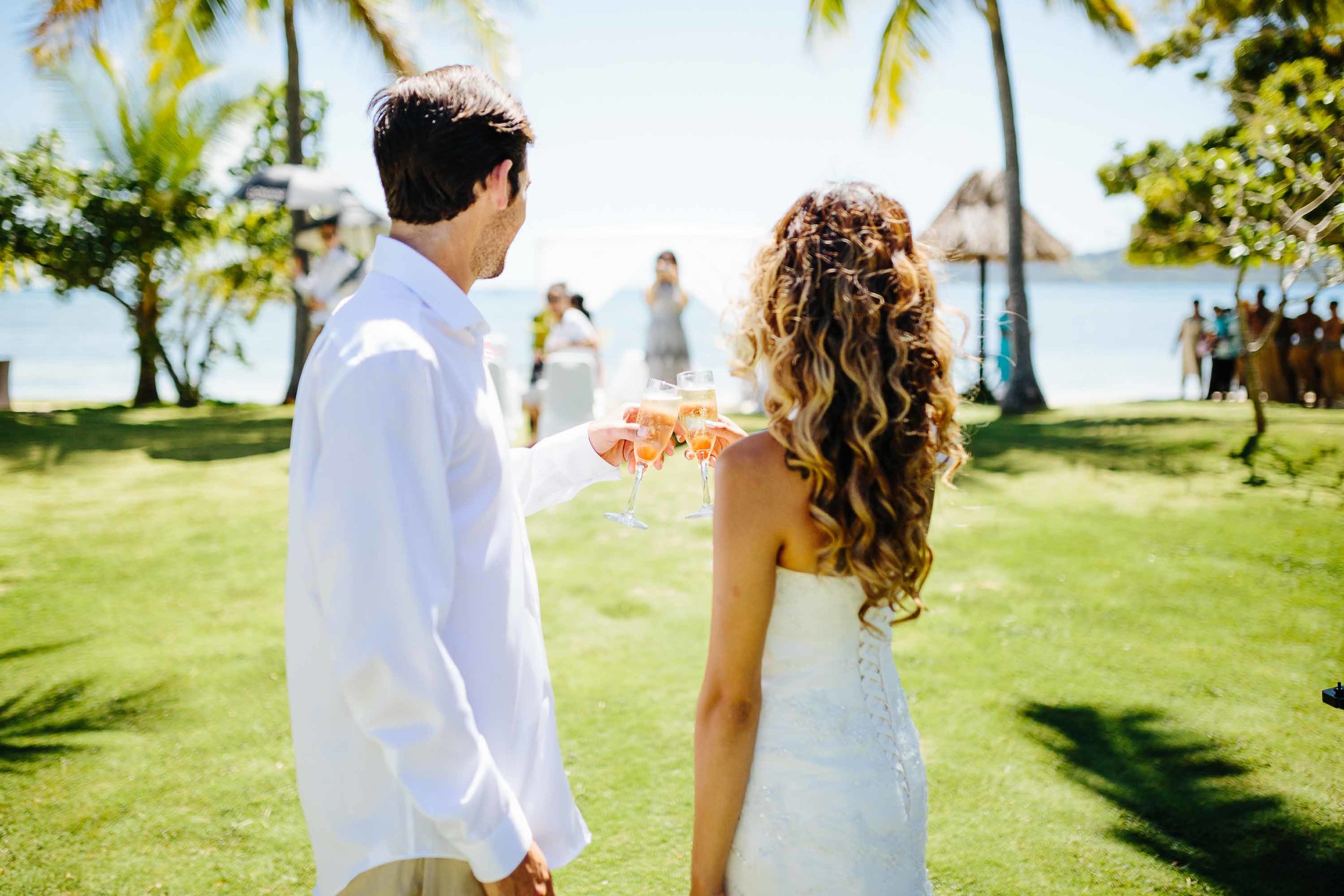 bridal couple enjoying sparkling wine after ceremony