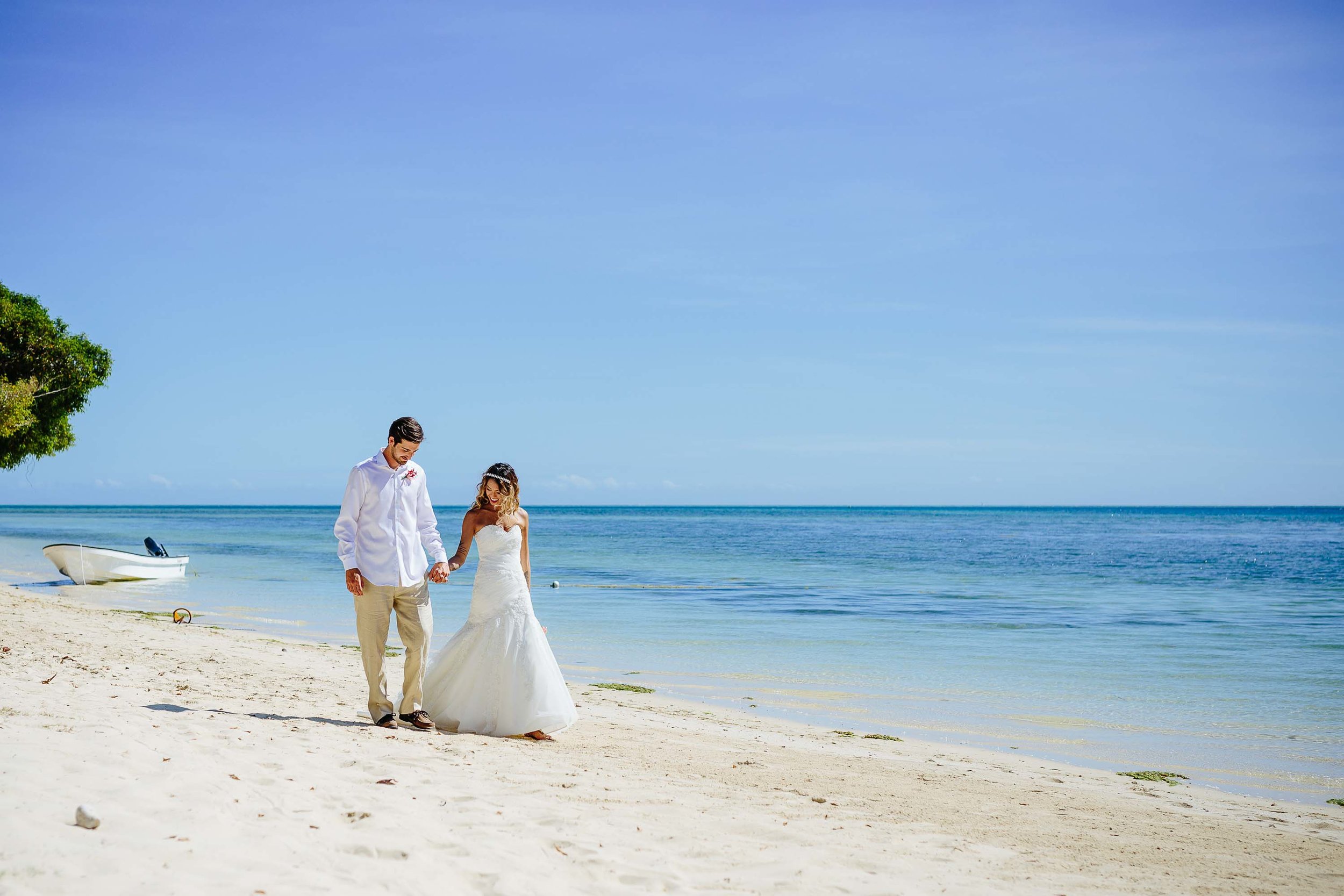 Bride and groom walking along the beach
