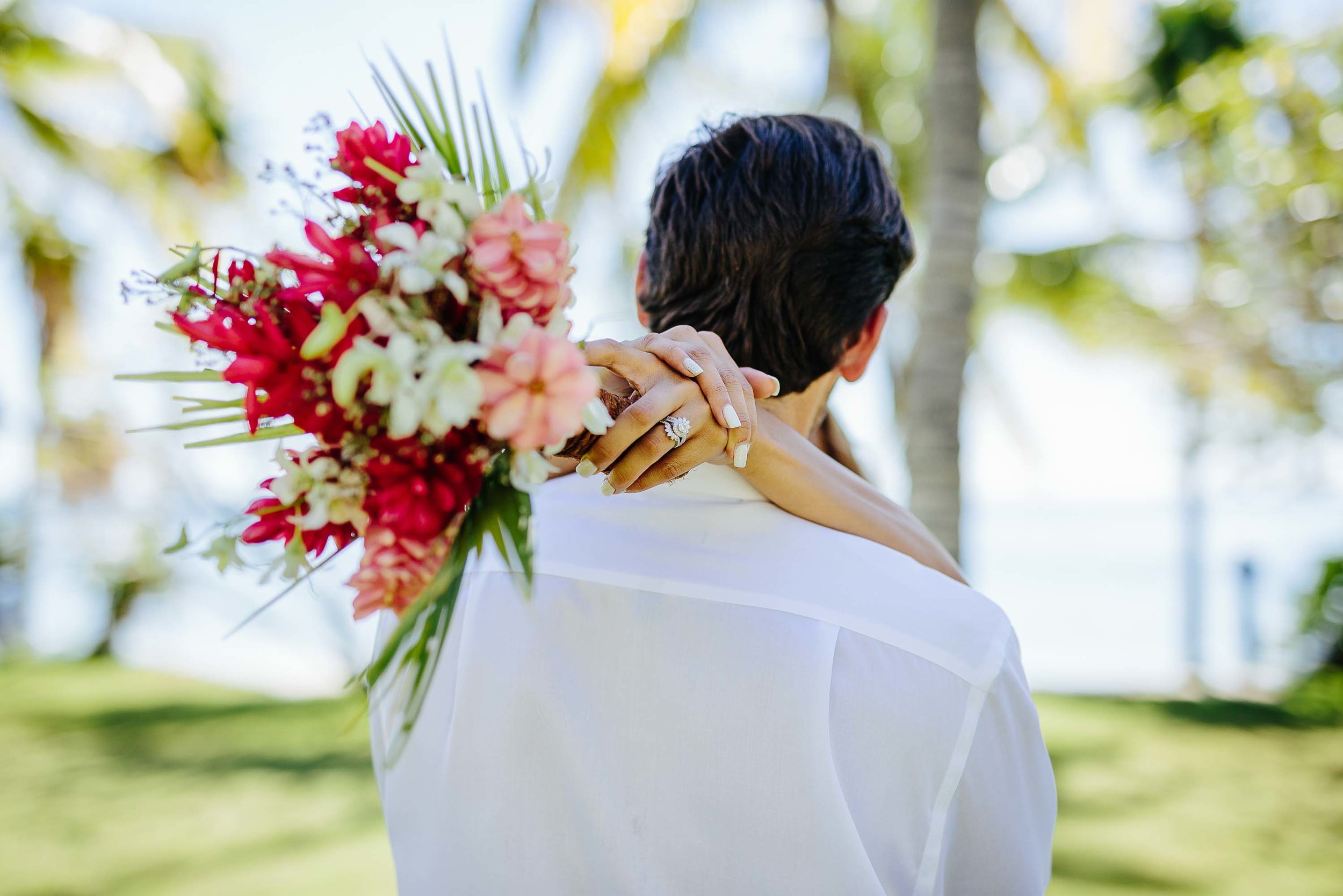 Bride hugging groom with bouquet