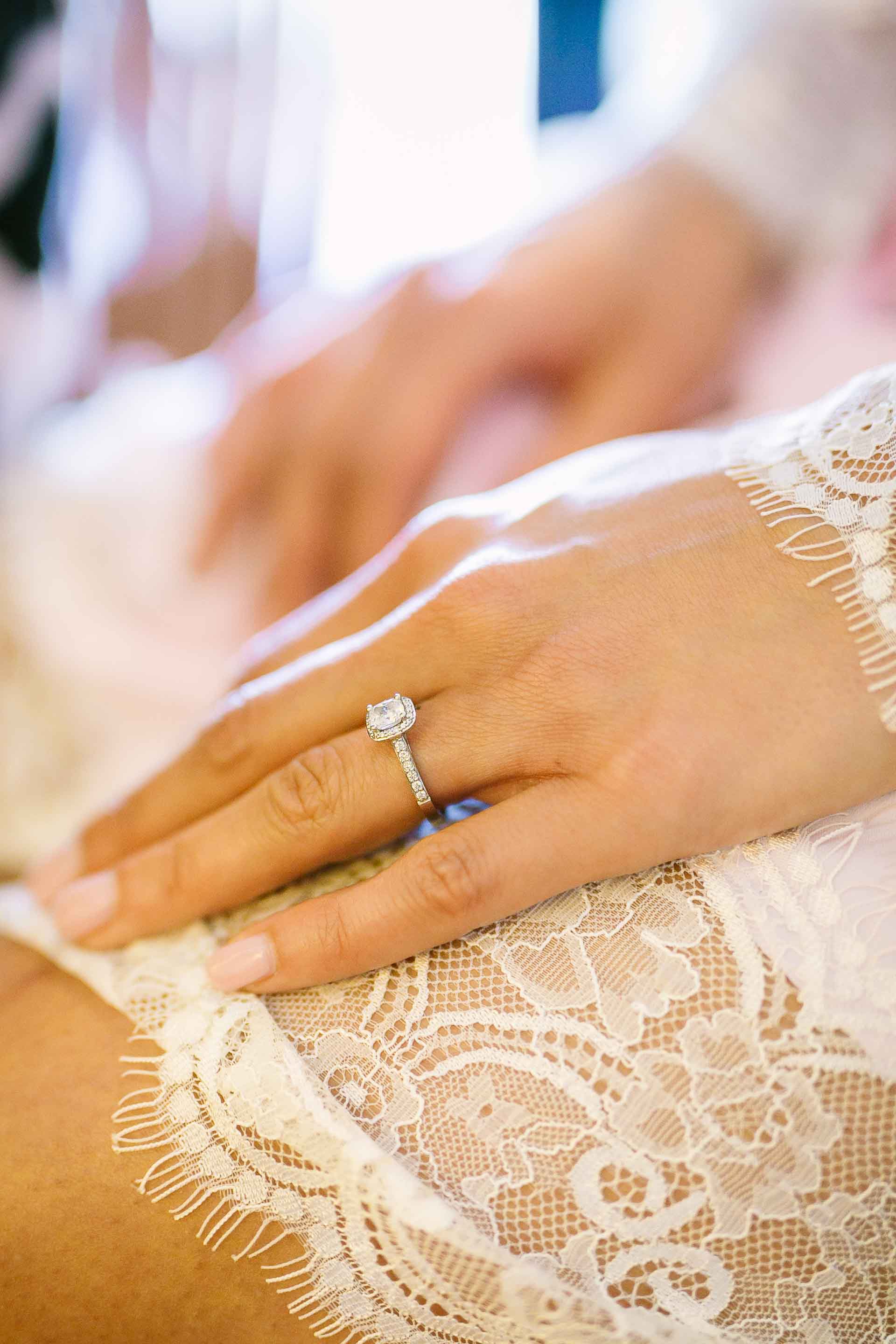 bride resting her hand on her thigh as she has her makeup done