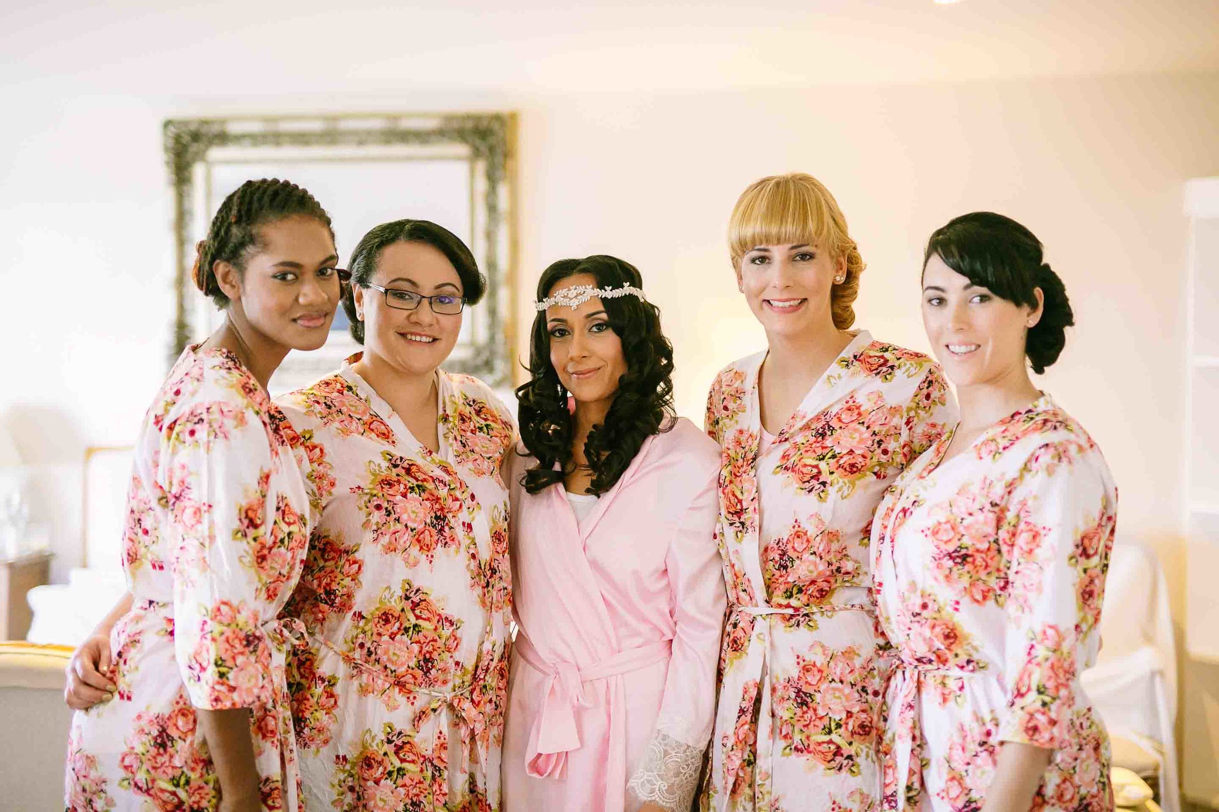 bride with her bridesmaids in their robes