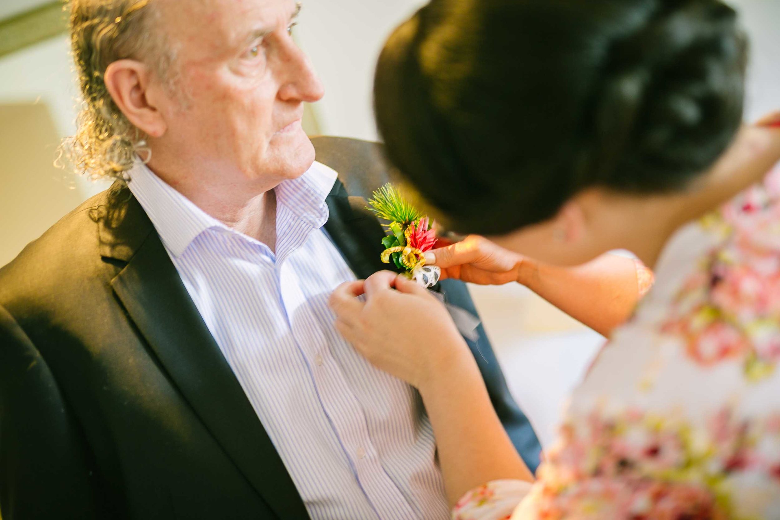 bridesmaid helping father of the bride with his Boutonnière