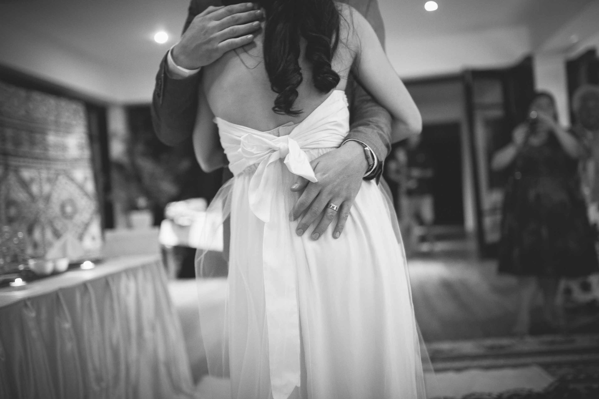 groom holding his bride close