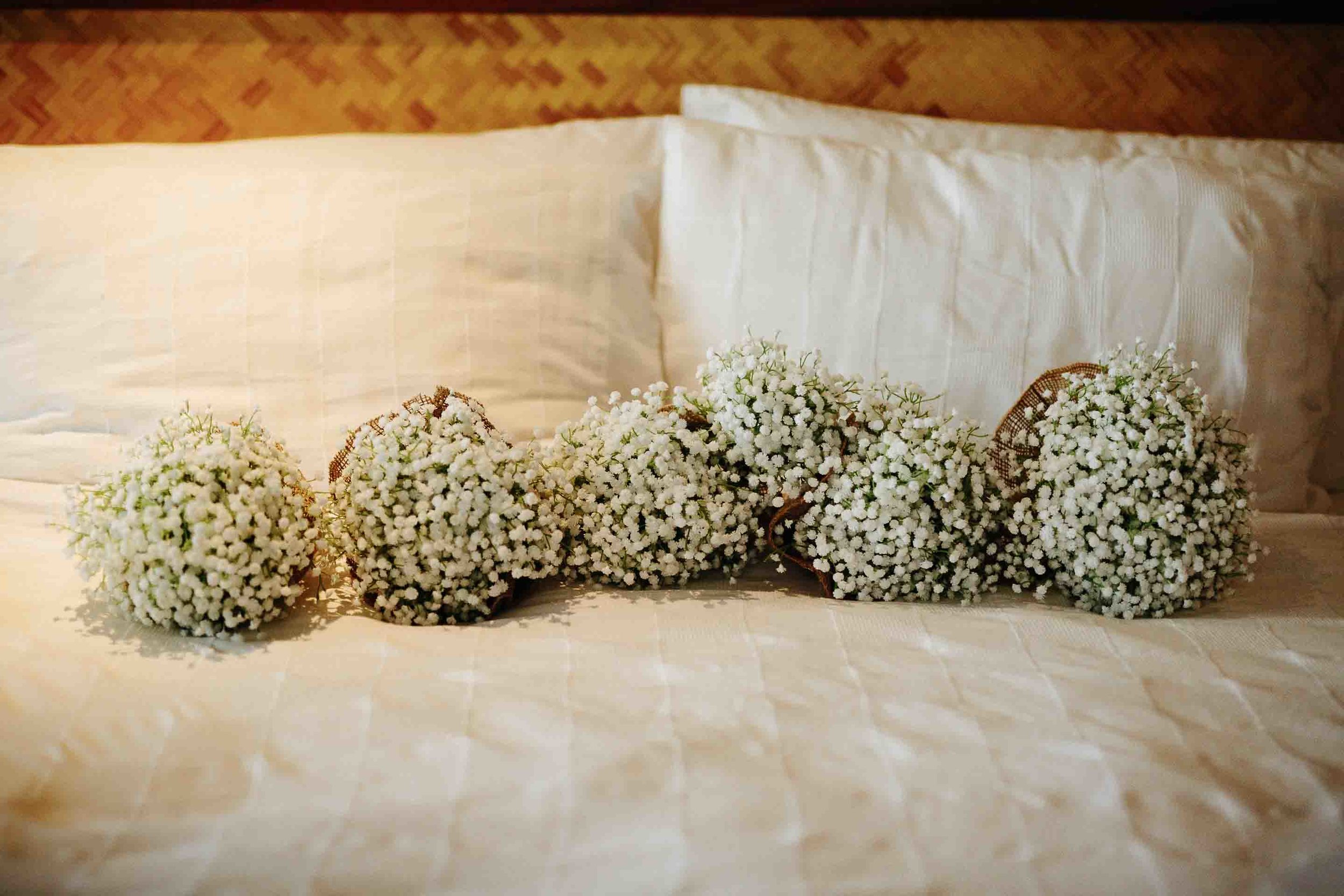 bridal bouquets lined up on the bed