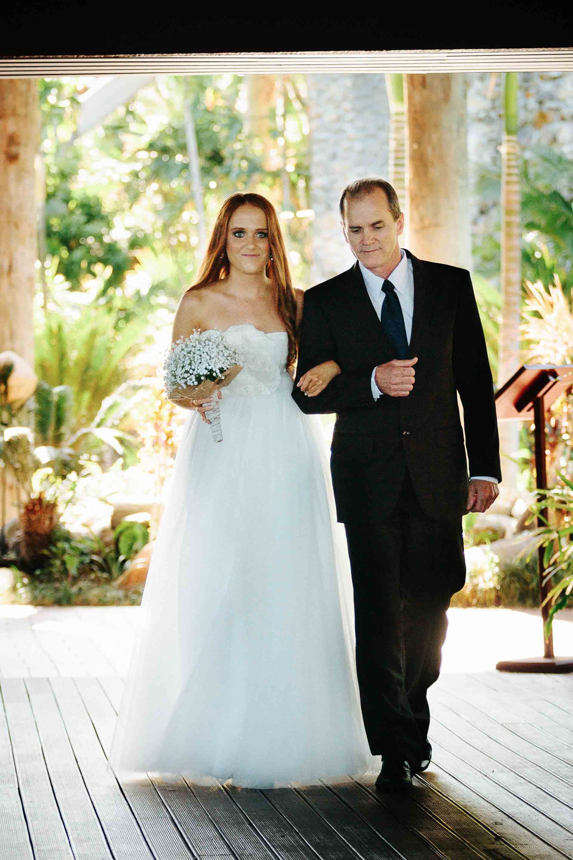 father and daughter walking down the asile together