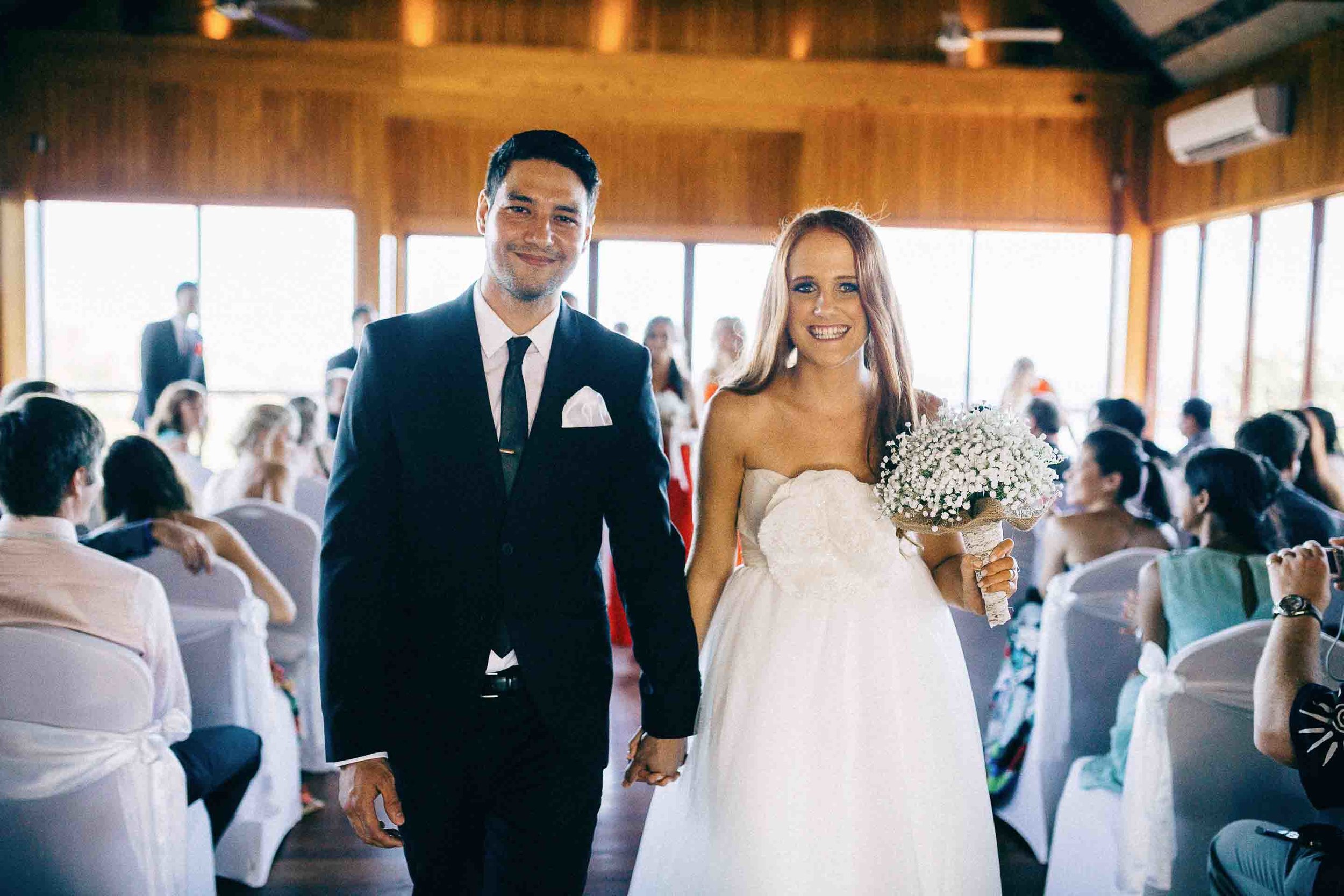 the bride and groom leaving the chapel as man and wife
