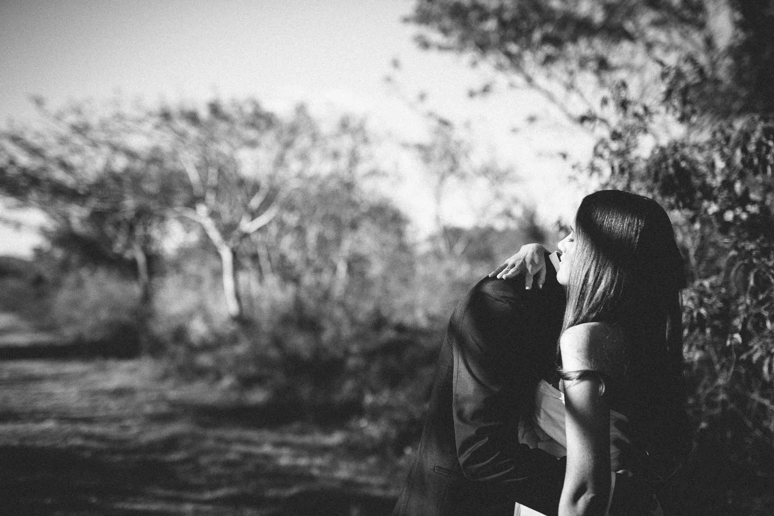 wide shot of bride hugging groom