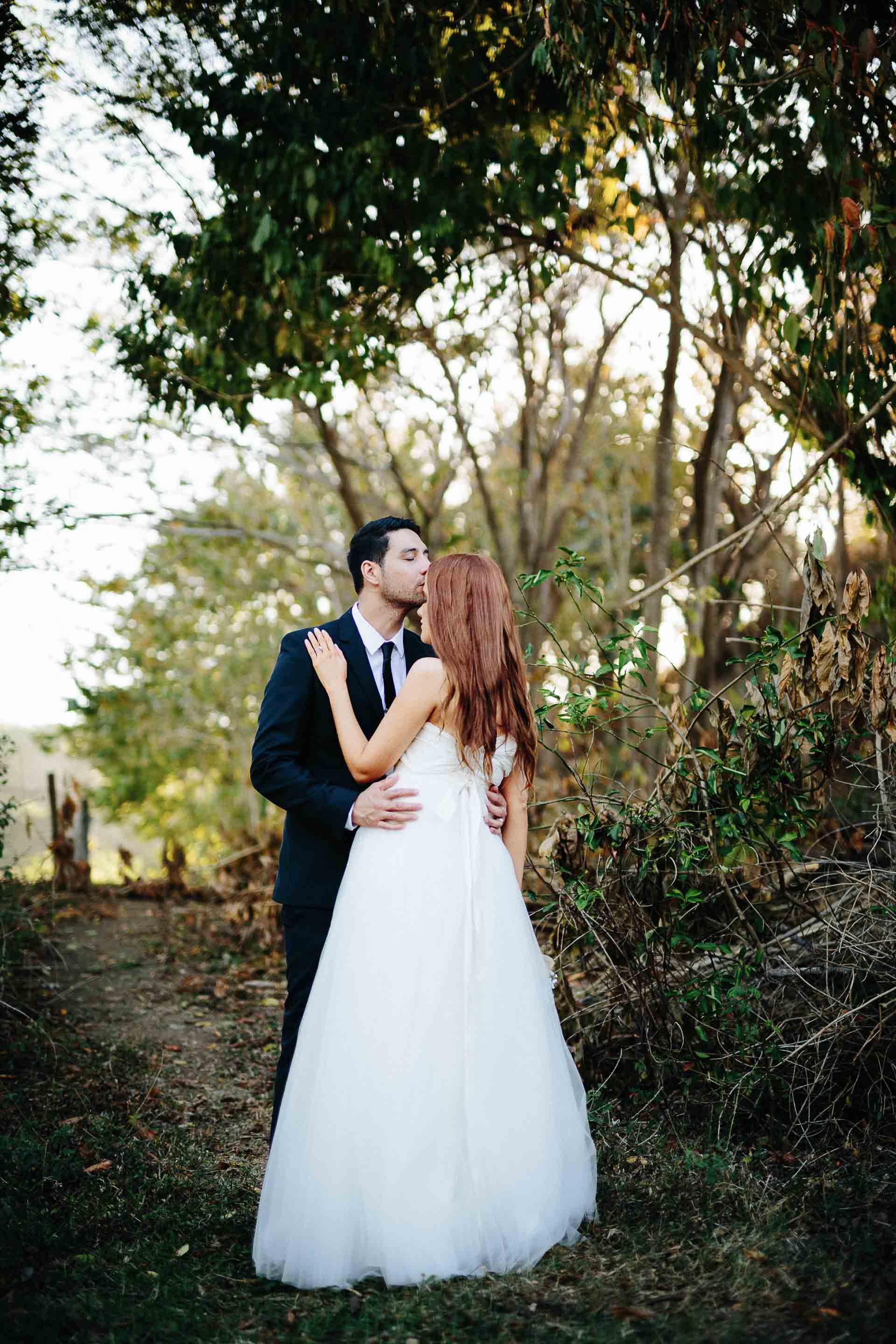 groom kissing bride on forehead