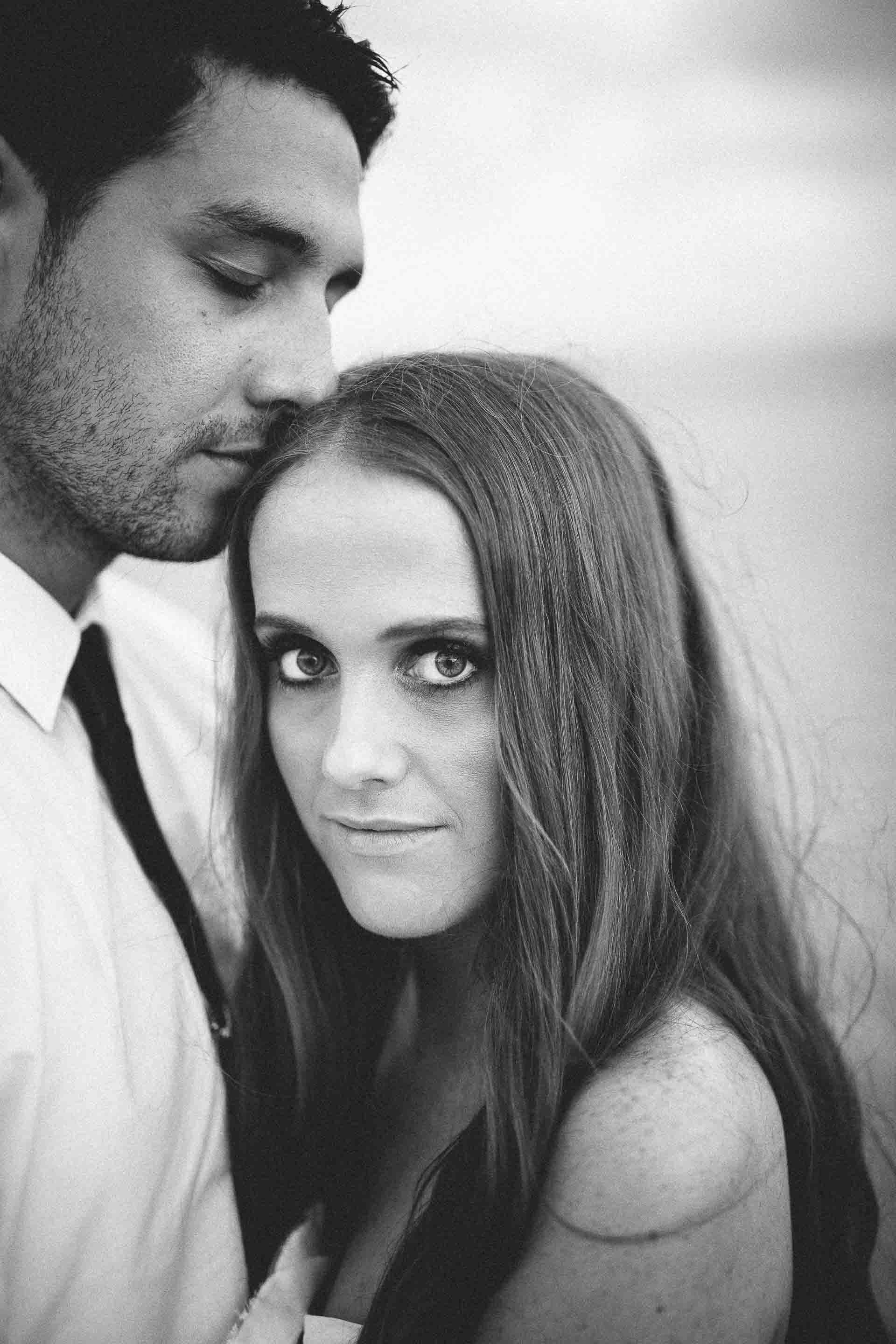 black and white couple portait with the bride looking straight at the camera