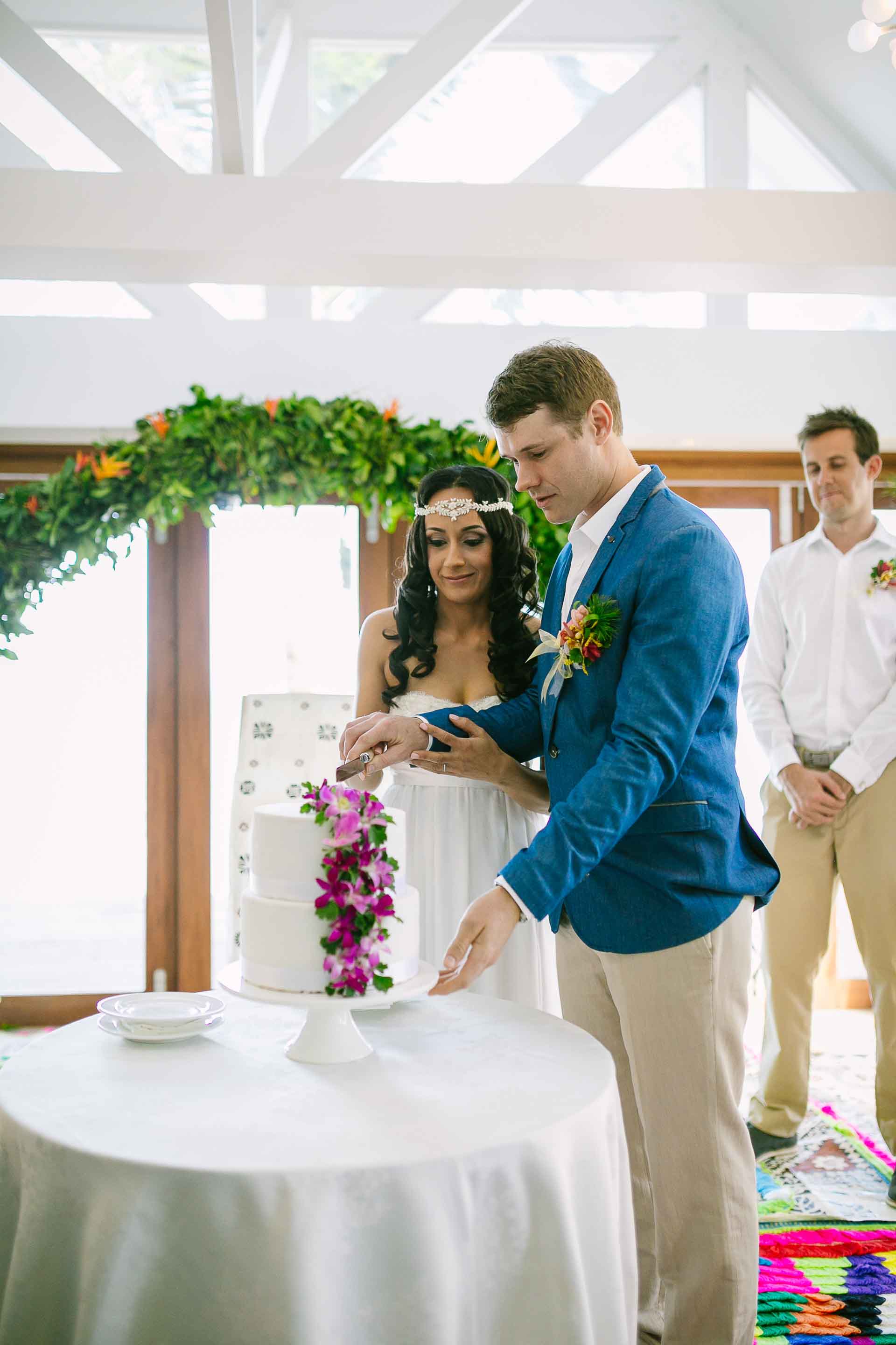 bride and groom cutting the cake