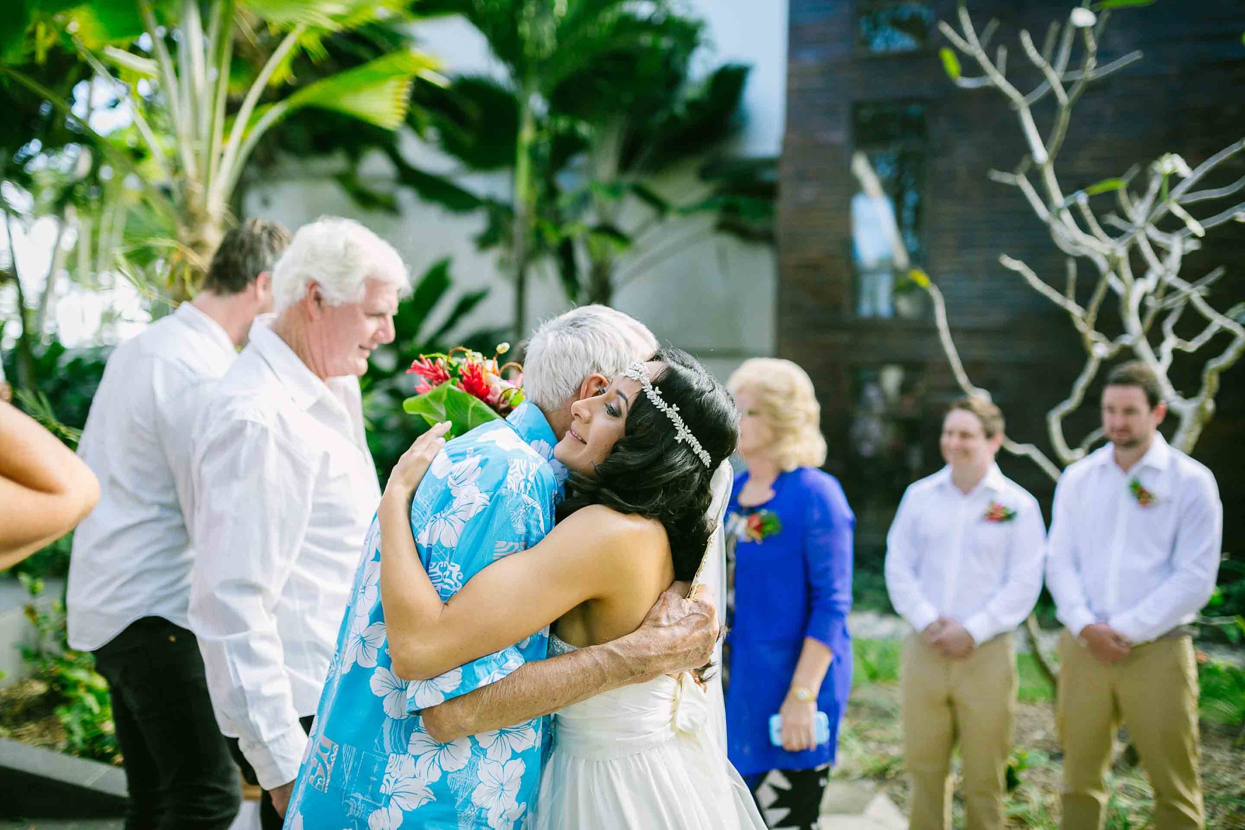 the grooms grandfather and bride hugging