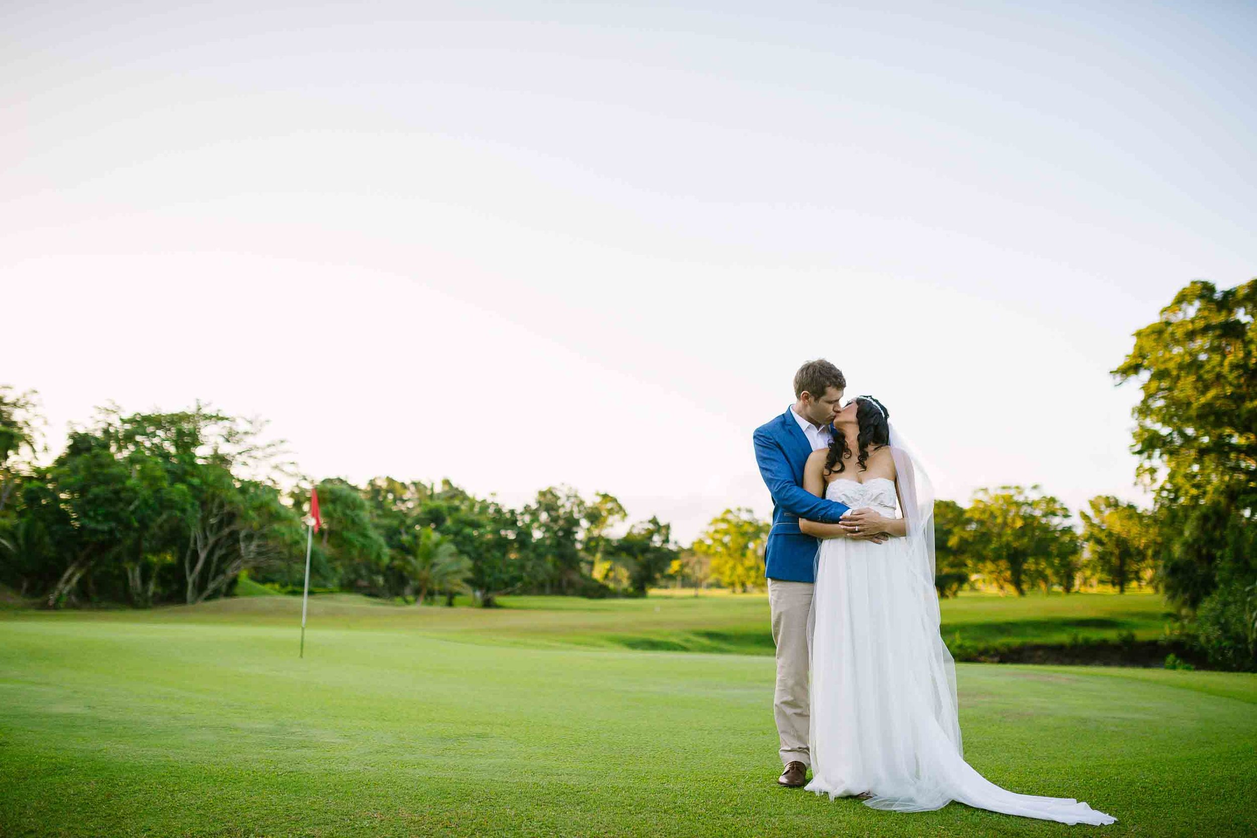 a portrait of the couple on the Pearl Championship Fiji Golf Course