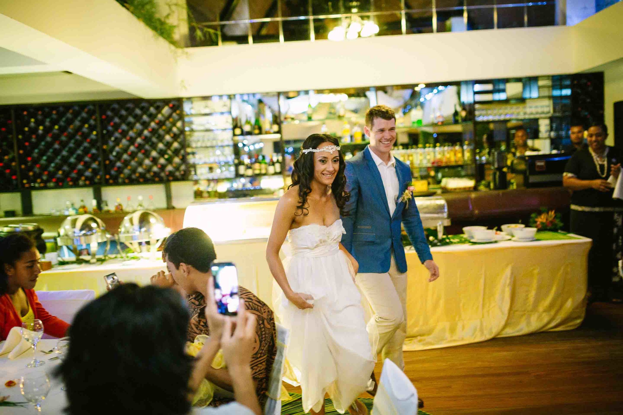 bride and groom entering their reception dinner